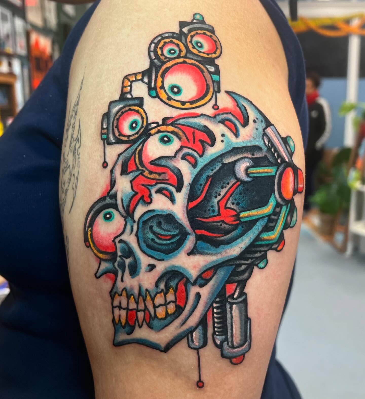 Mechanical skull American traditional tattoo on the shoulder by Matt E.