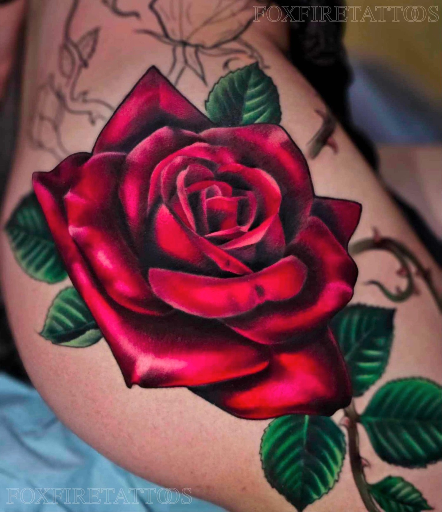 Red rose realism tattoo on the thigh by Lindsey Chevalier - KCMO TATTOO ARTIST