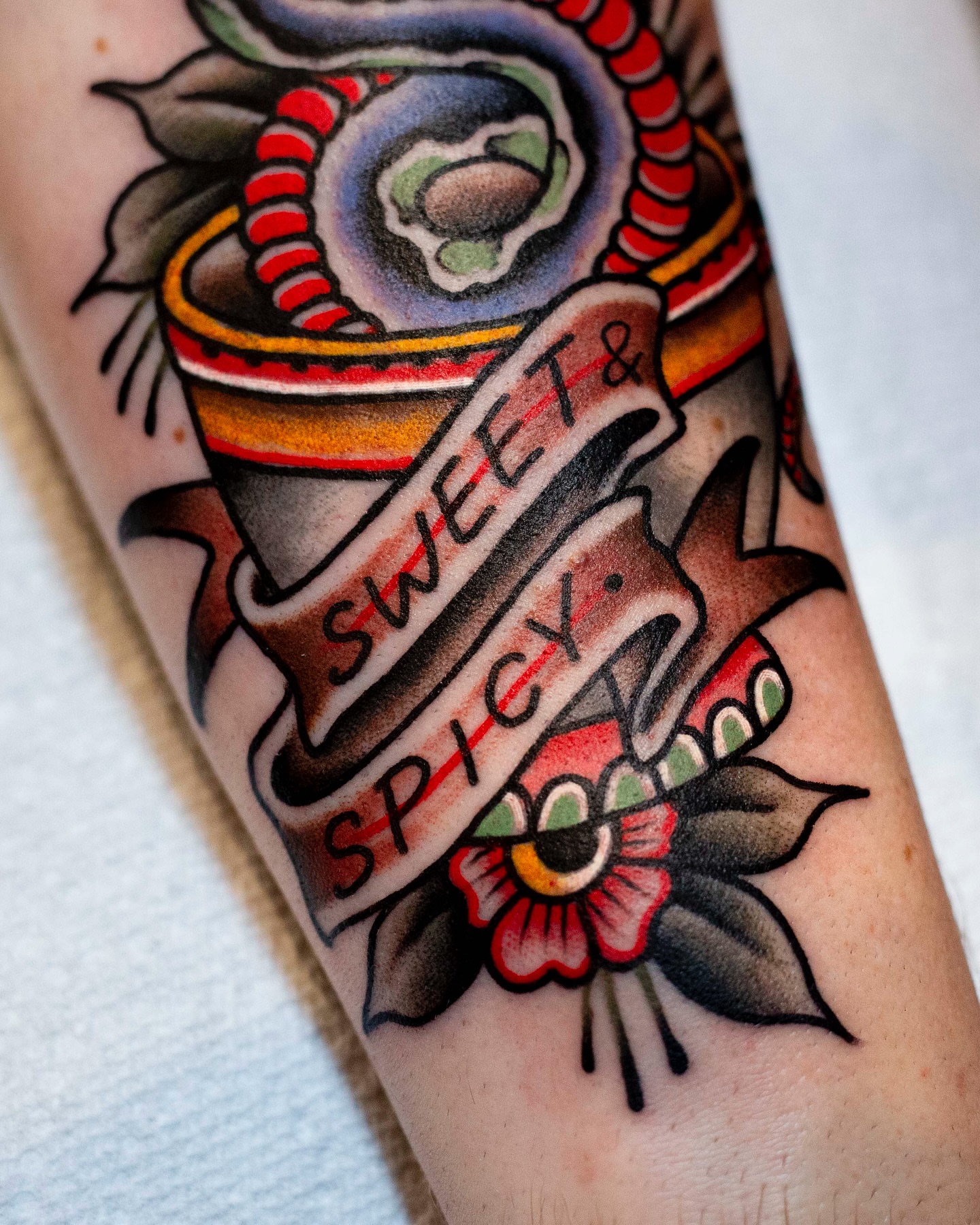 Sweet & spicy American traditional tattoo on the forearm by Miguel Comin