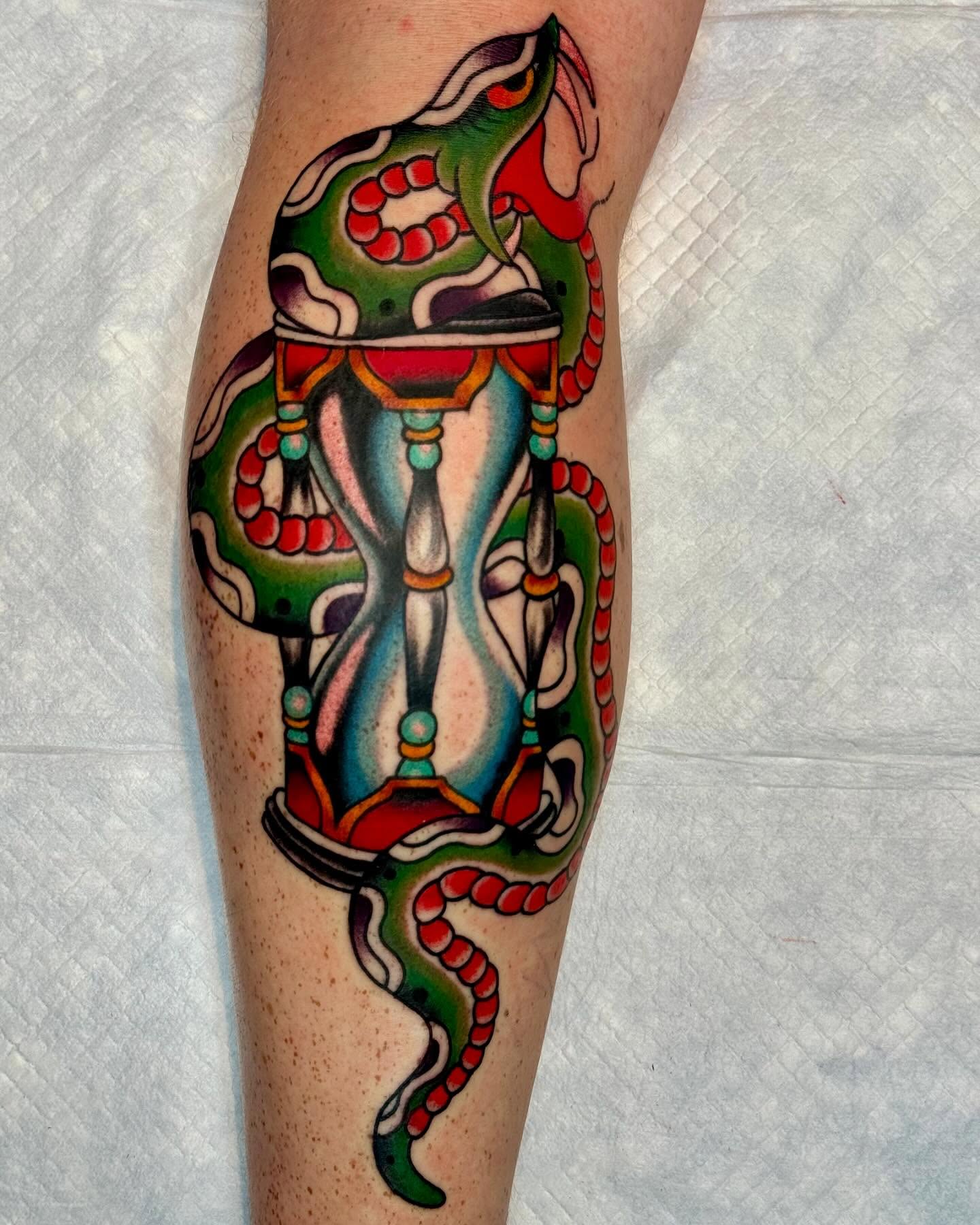 Snake and hourglass American traditional tattoo on the forearm by Dustin Paul Fowler, New York, New York