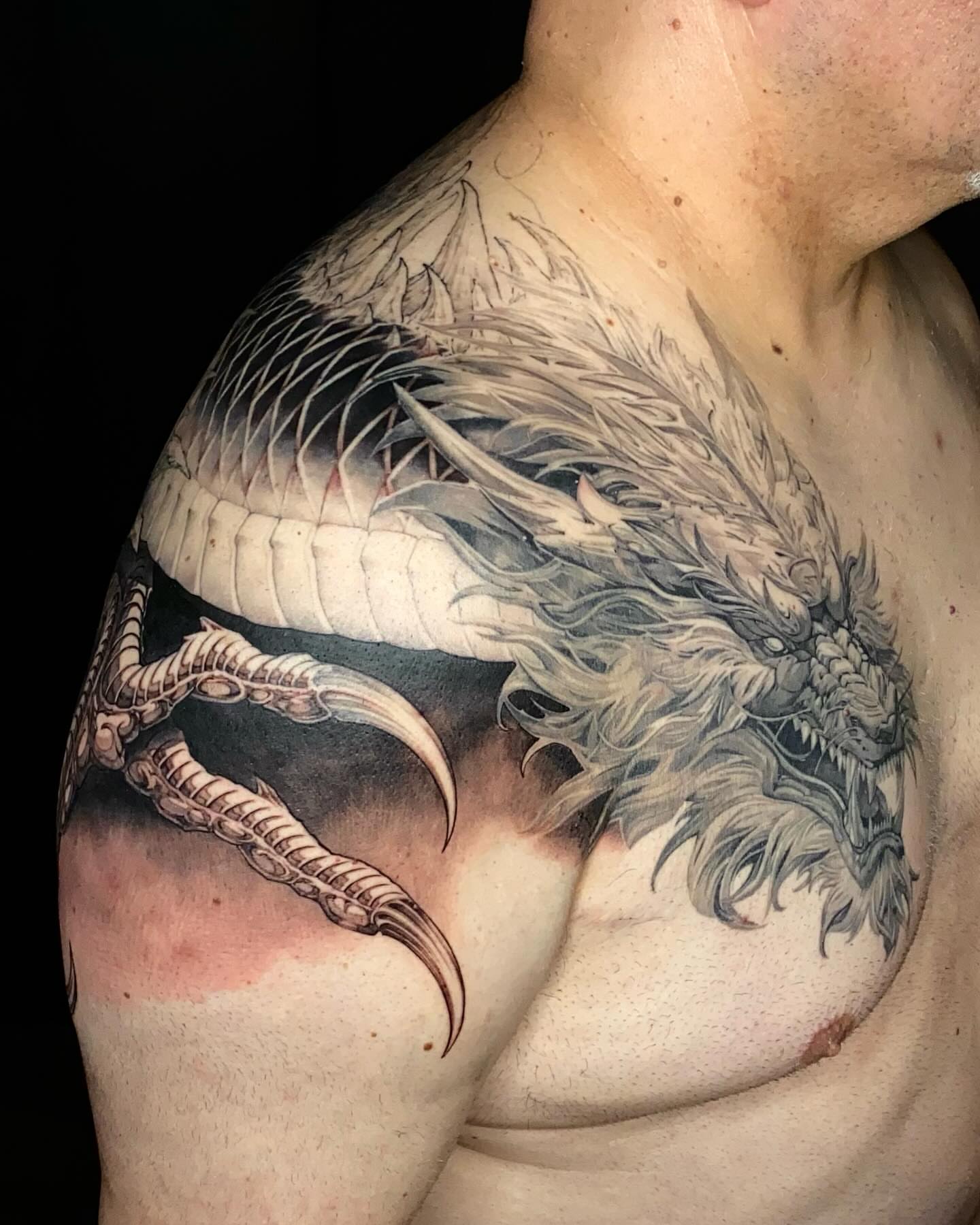 Dragon black and grey tattoo on the shoulder by Gerardo Brawder