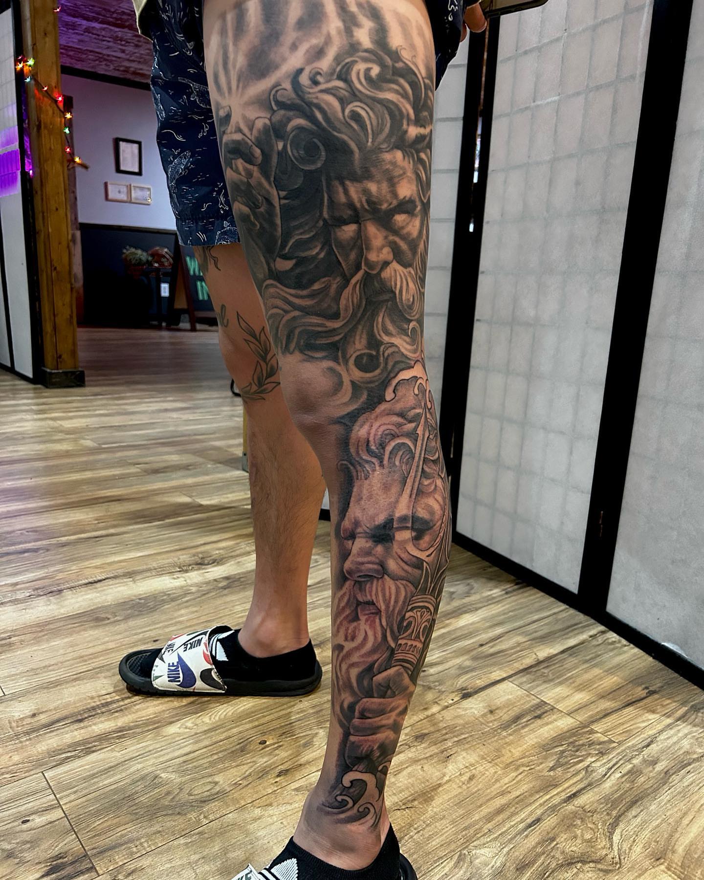 Godly figures realism tattoo on the leg by Cody Lambert