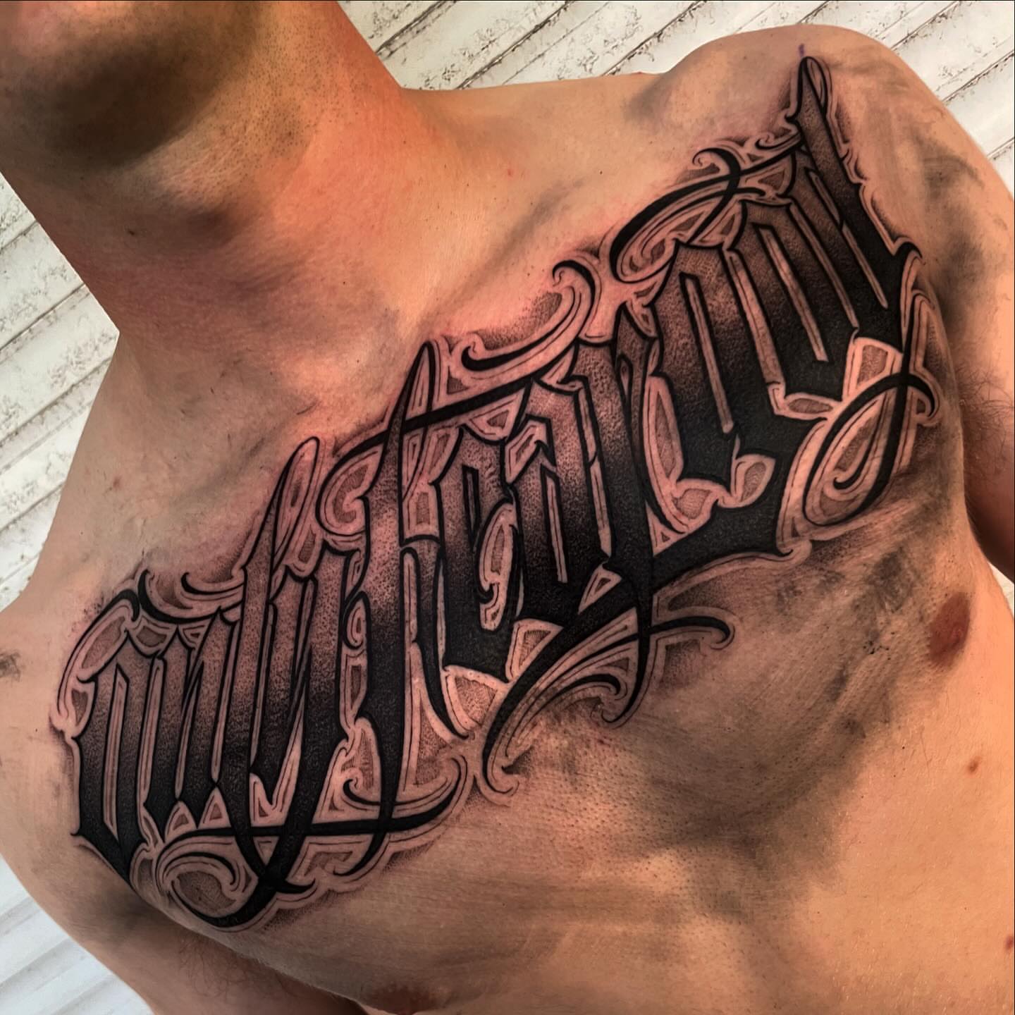 Script lettering lettering script tattoo on the chest by Chicanocustomlettering
