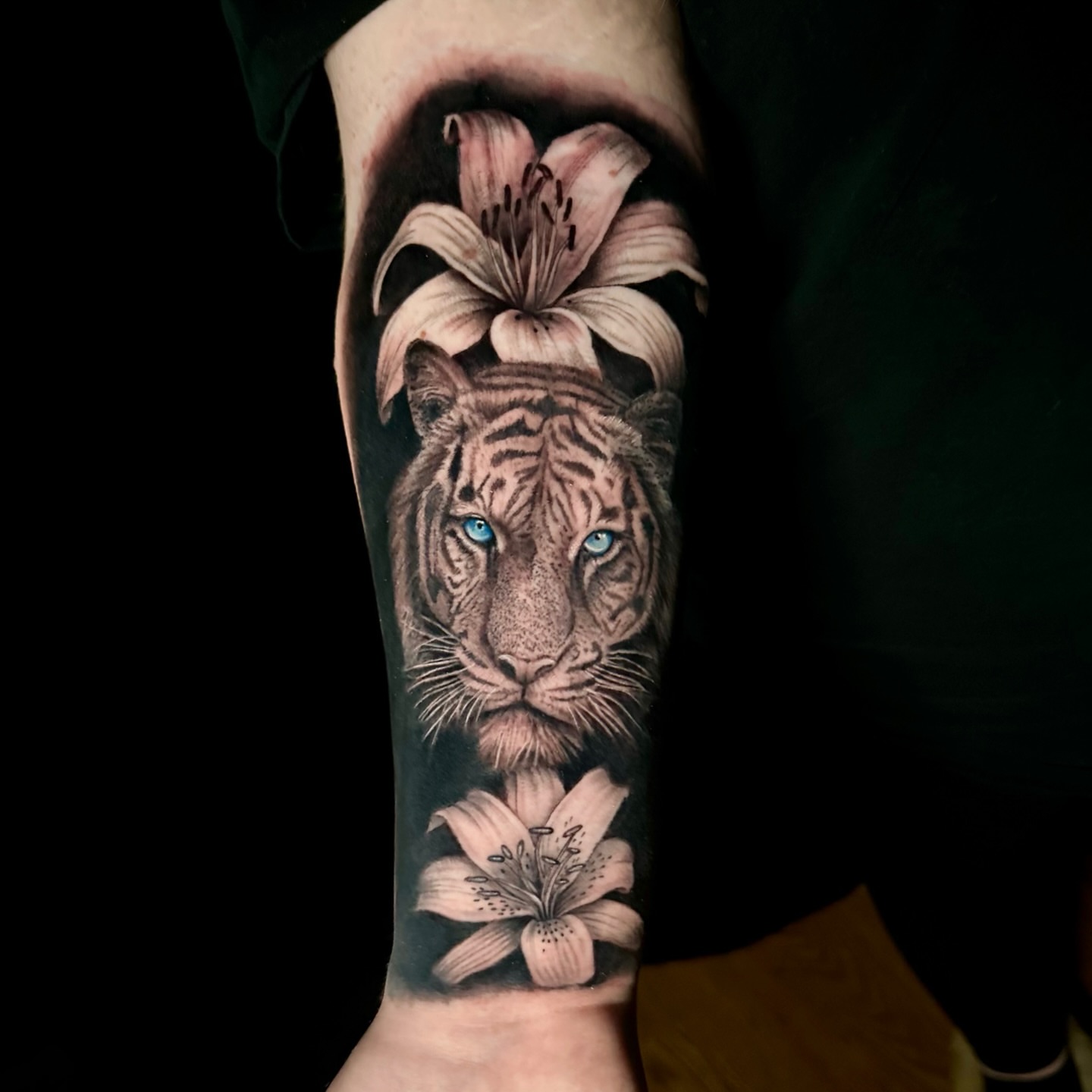 Tiger and lilies realism tattoo on the forearm by Tyler Reep