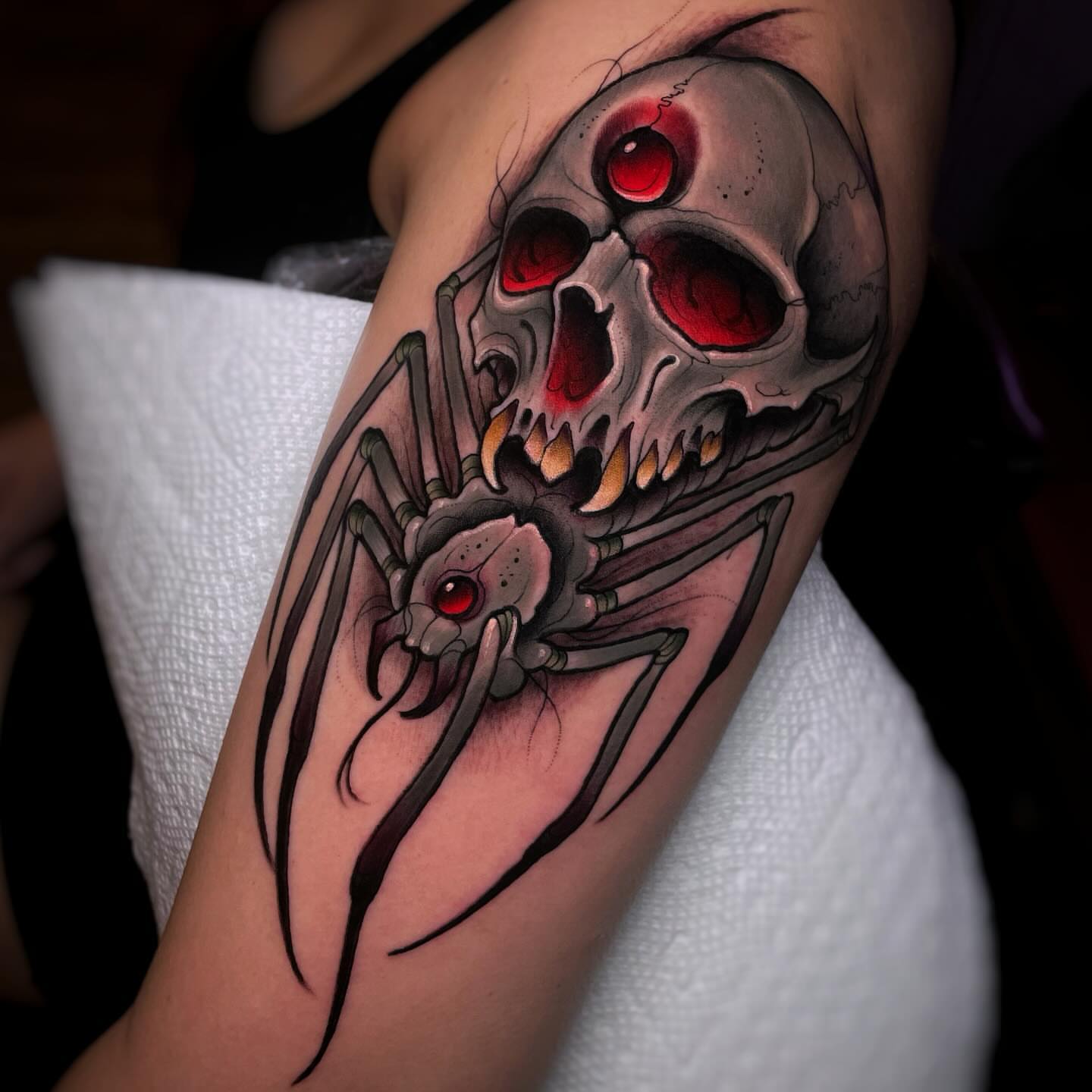 Skull and spider dark realism tattoo on the forearm by Ick Abrams