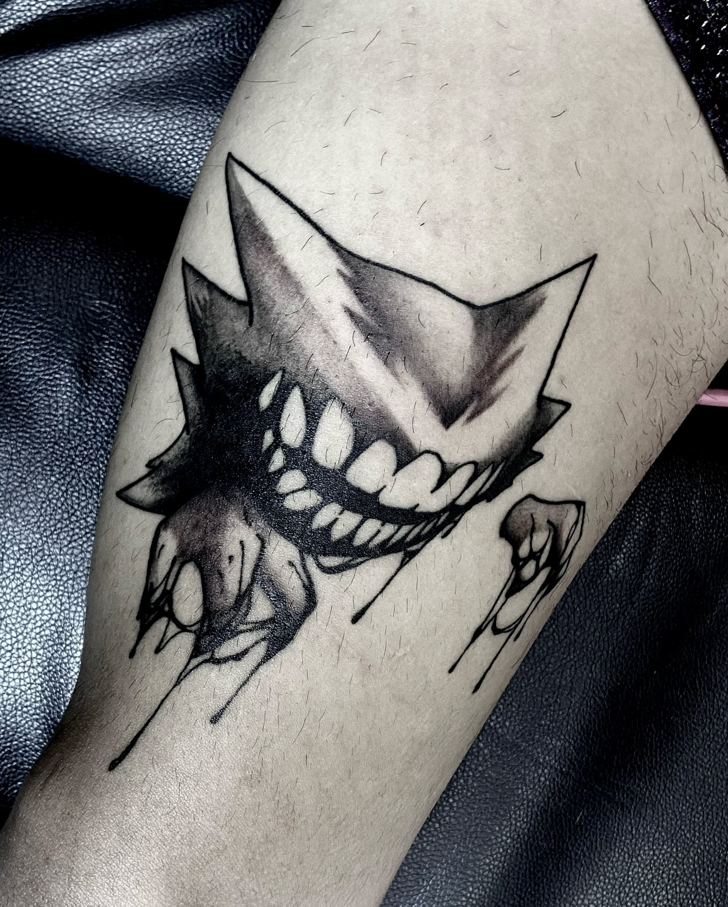 Fangs and spikes black and grey tattoo on the forearm by Nathan