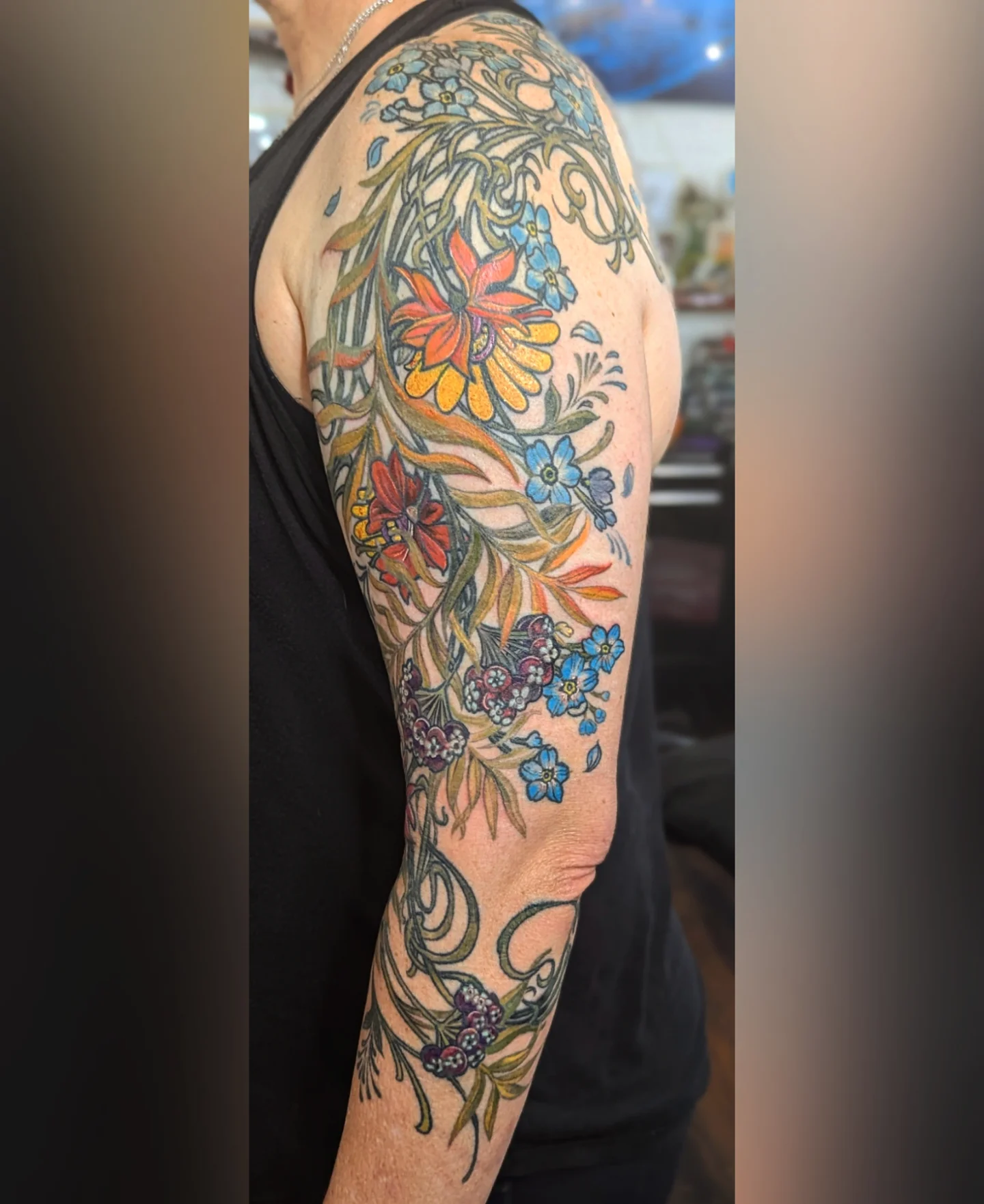 Floral bouquet new school tattoo on the upper arm by Ashton Allen-Ruiz, Portland, Oregon