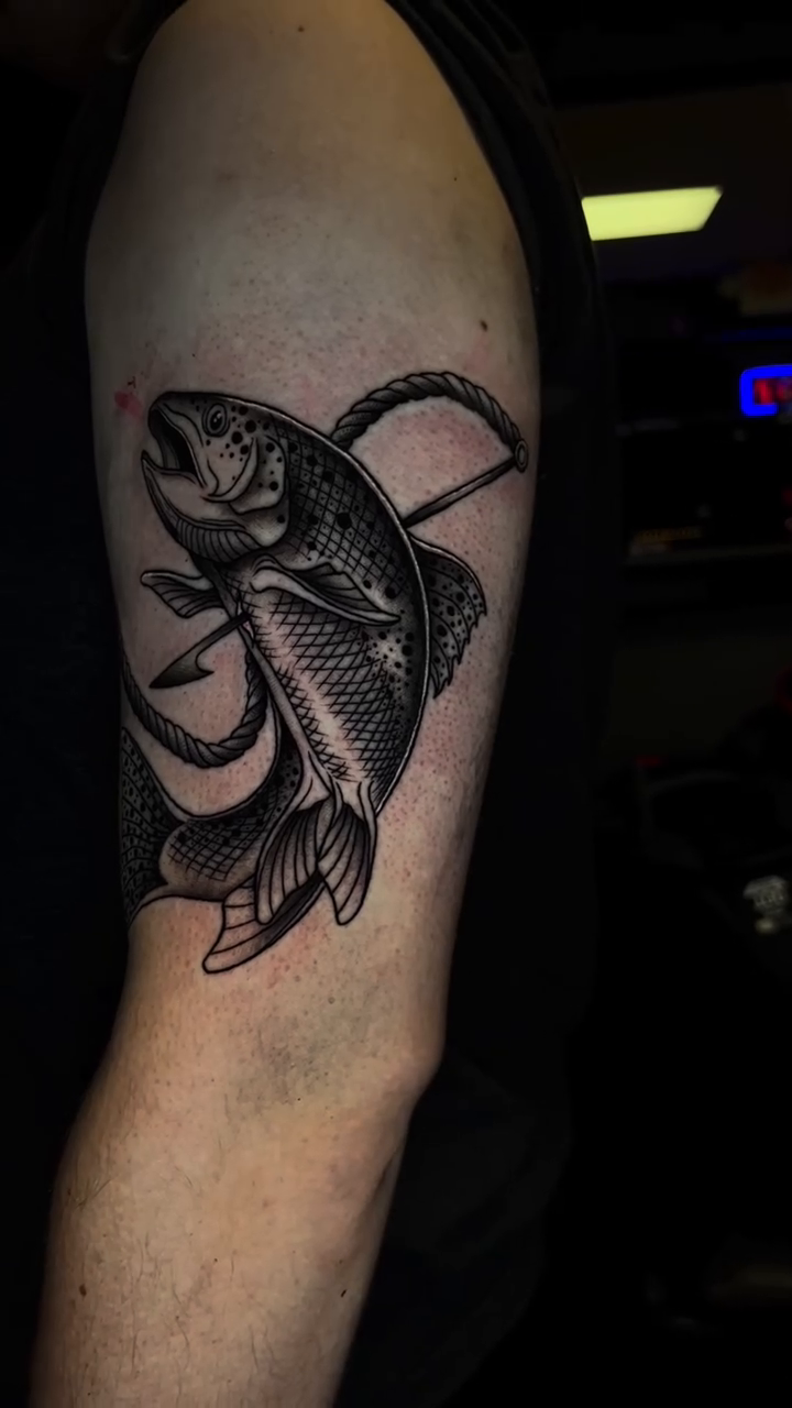 Fish on a fishing hook realism tattoo by Connor Arvay