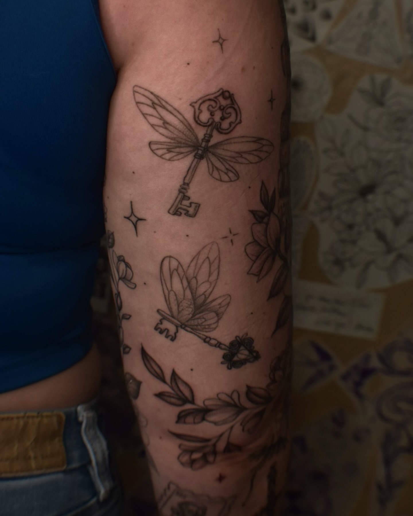 Dragonfly key black and grey tattoo on the forearm by Alexandria Gudiel