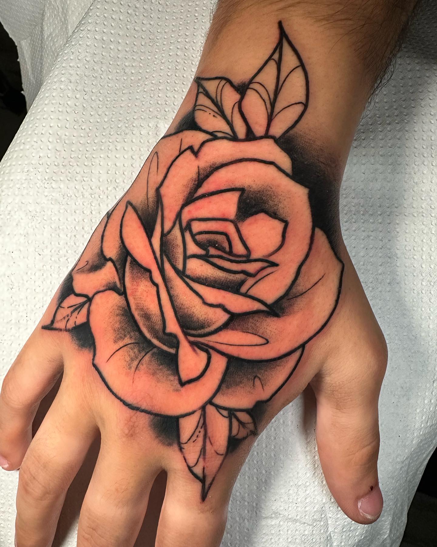 Rose black and grey tattoo on the hand by Marta La Jirafa