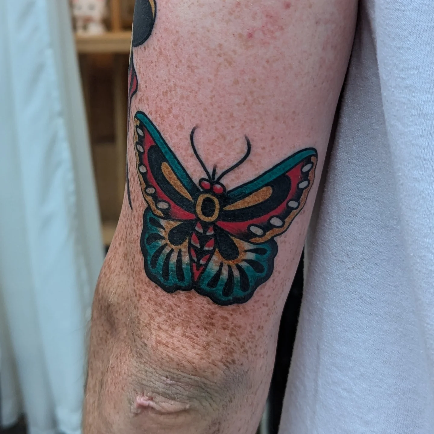 Butterfly American traditional tattoo on the forearm by Zack Mueller