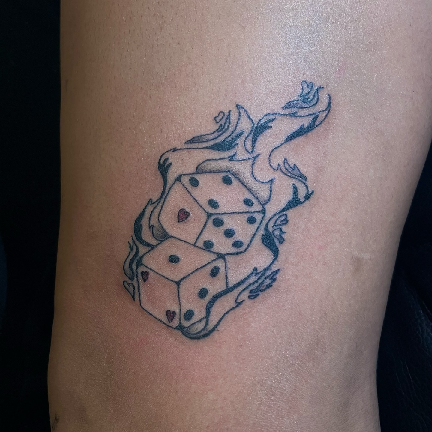 Dice and dragon black and grey tattoo on the thigh by miranda