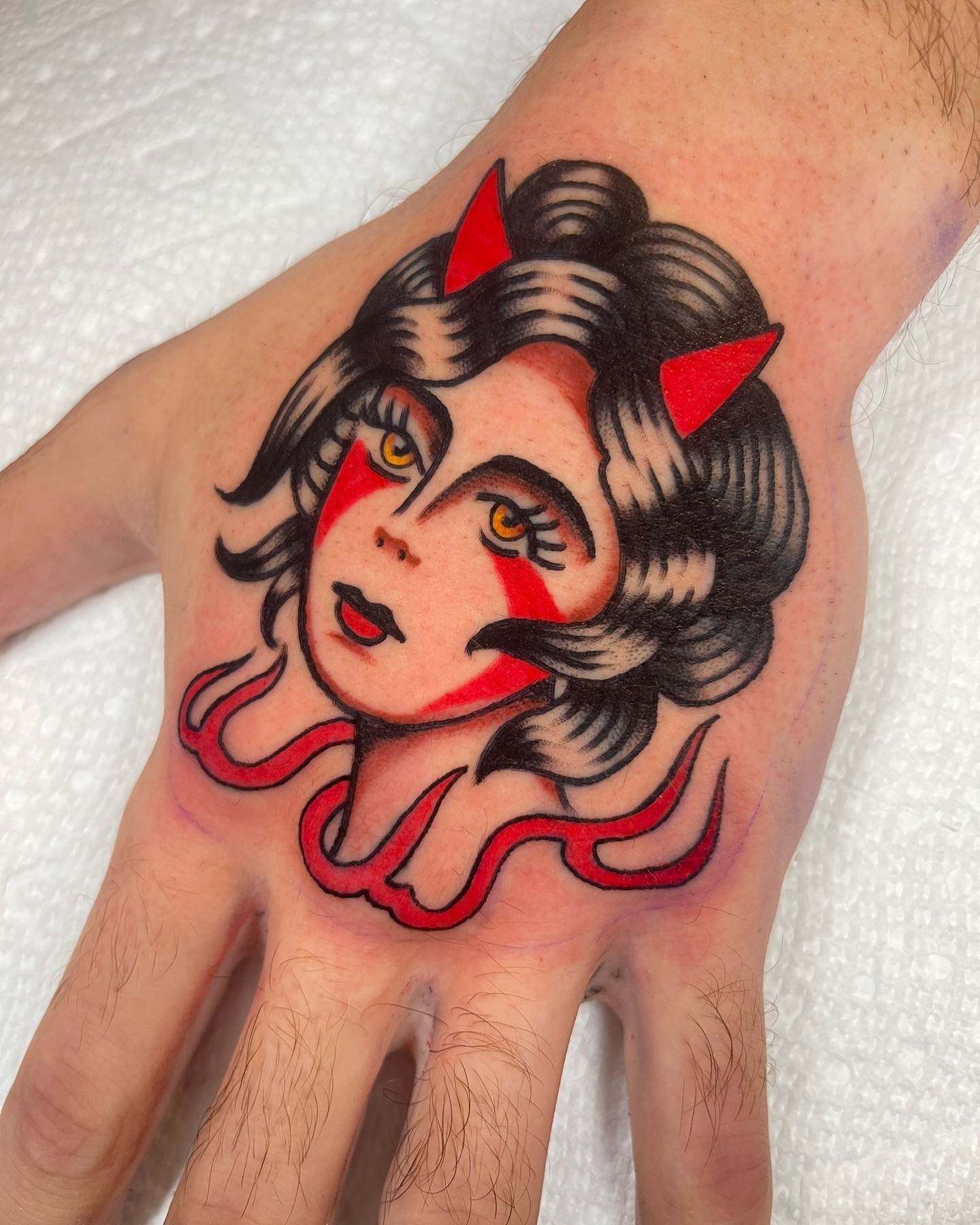 Woman with horns American traditional tattoo on the hand by Jeff Miller philly traditional tattoo