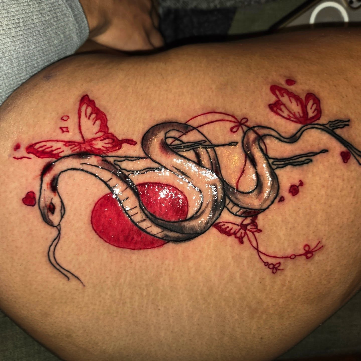 Snake and heart American traditional tattoo on the thigh by Trent Johnson