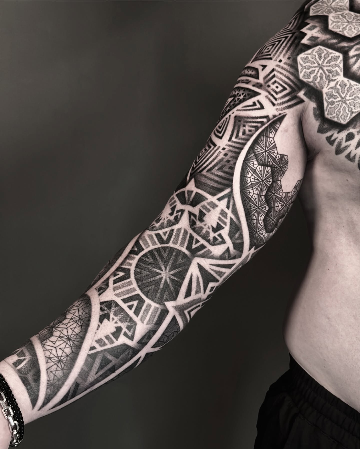 Geometric patterns geometric tattoo on the upper arm by Nick Fierro