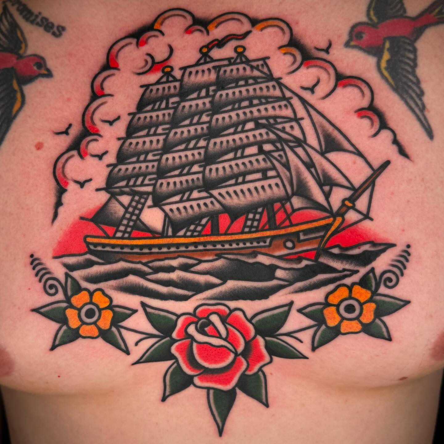 Ship and flowers American traditional tattoo on the chest by John Lemon