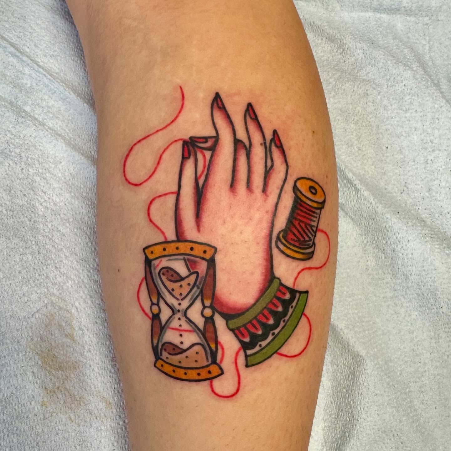 Hourglass, hand, spool of thread American traditional tattoo on the forearm by 𝙹𝙴𝚆𝙴𝙻𝚂 𝙸𝙳𝙴𝚃𝚃𝙴 𝙳𝙸𝚃𝚃𝚁𝙸𝙲𝙷 (𝙻𝙰𝚂𝙾𝚃𝙰), Minneapolis, Minnesota