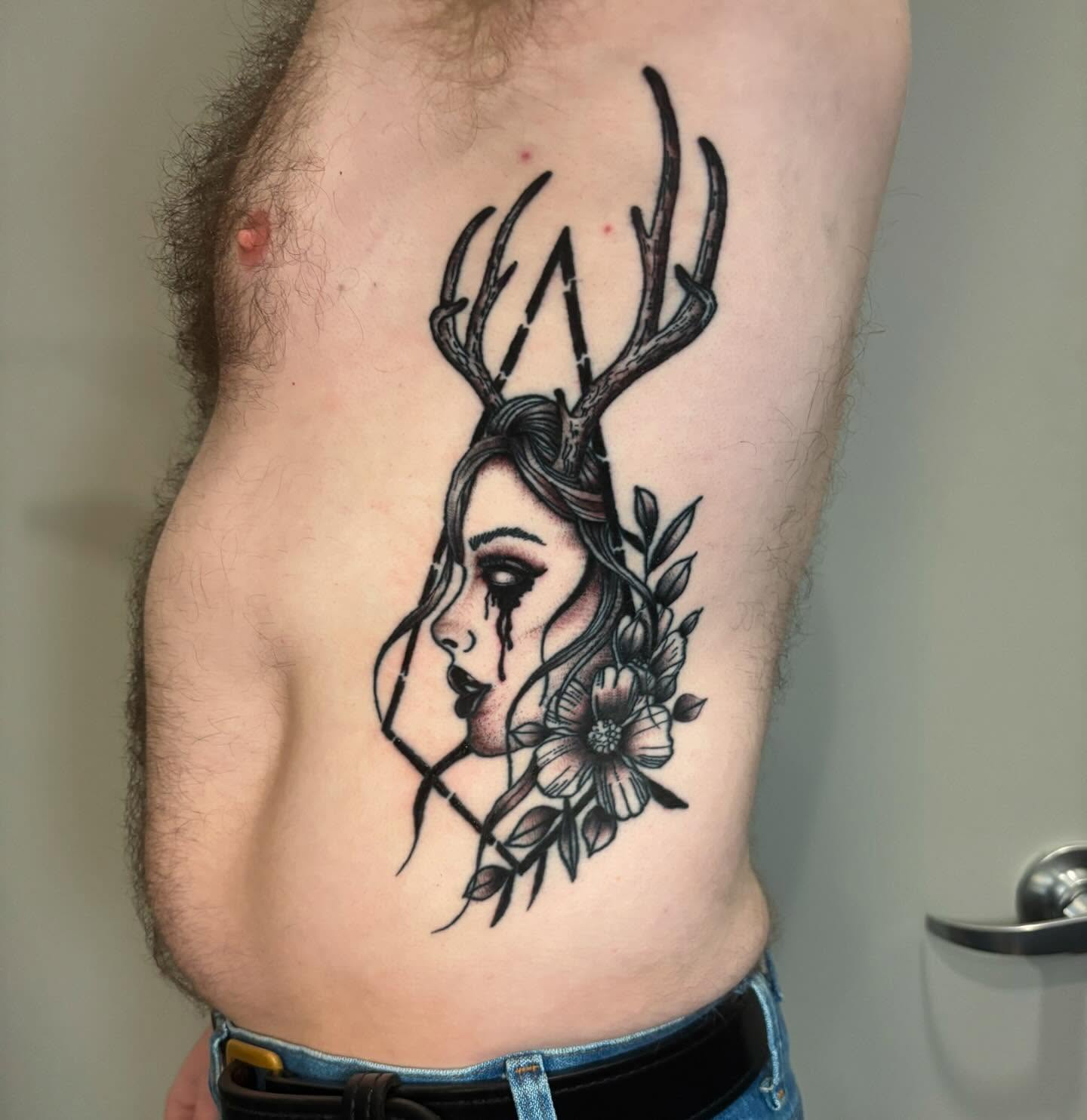 Deer head with woman's face realism tattoo on the ribs by Bryan Black
