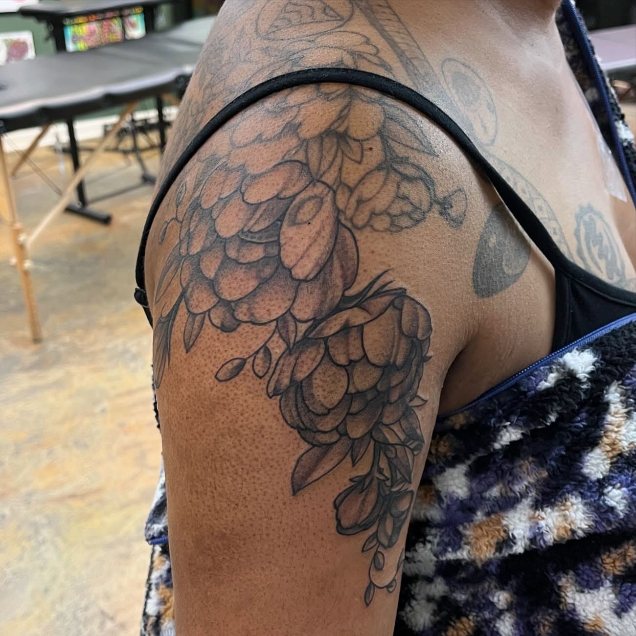 Hops black and grey tattoo on the shoulder by Dallas Davis
