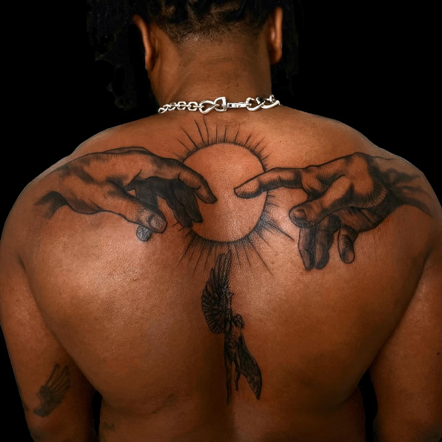 Hands and sun realism tattoo on the back by Asia Rene Tattoos👑