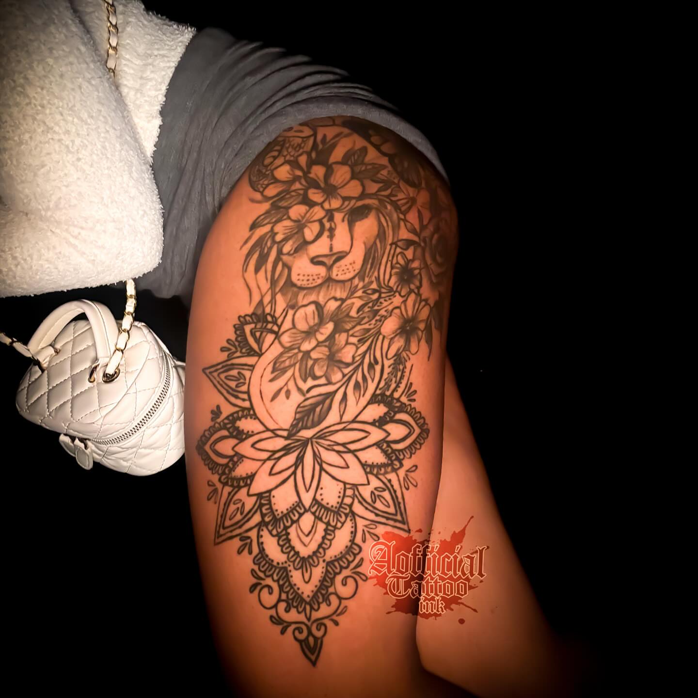 Lion and floral ornamental tattoo on the upper arm by Shane Boss, Toronto, Ontario