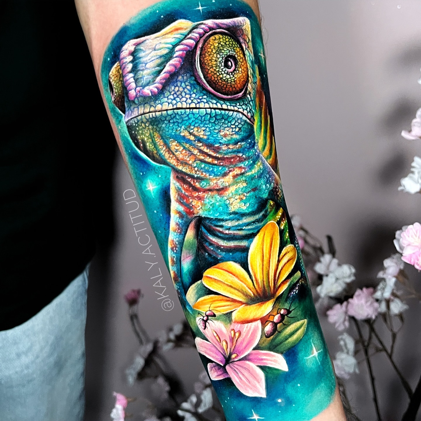 Chameleon with flowers watercolor tattoo on the forearm by Kaly, Manhattan, NYC
