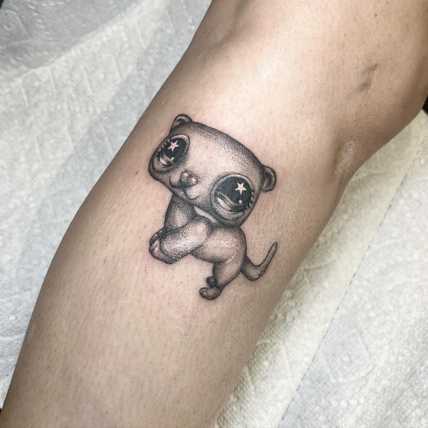 Space puppy dotwork tattoo on the forearm by aurora