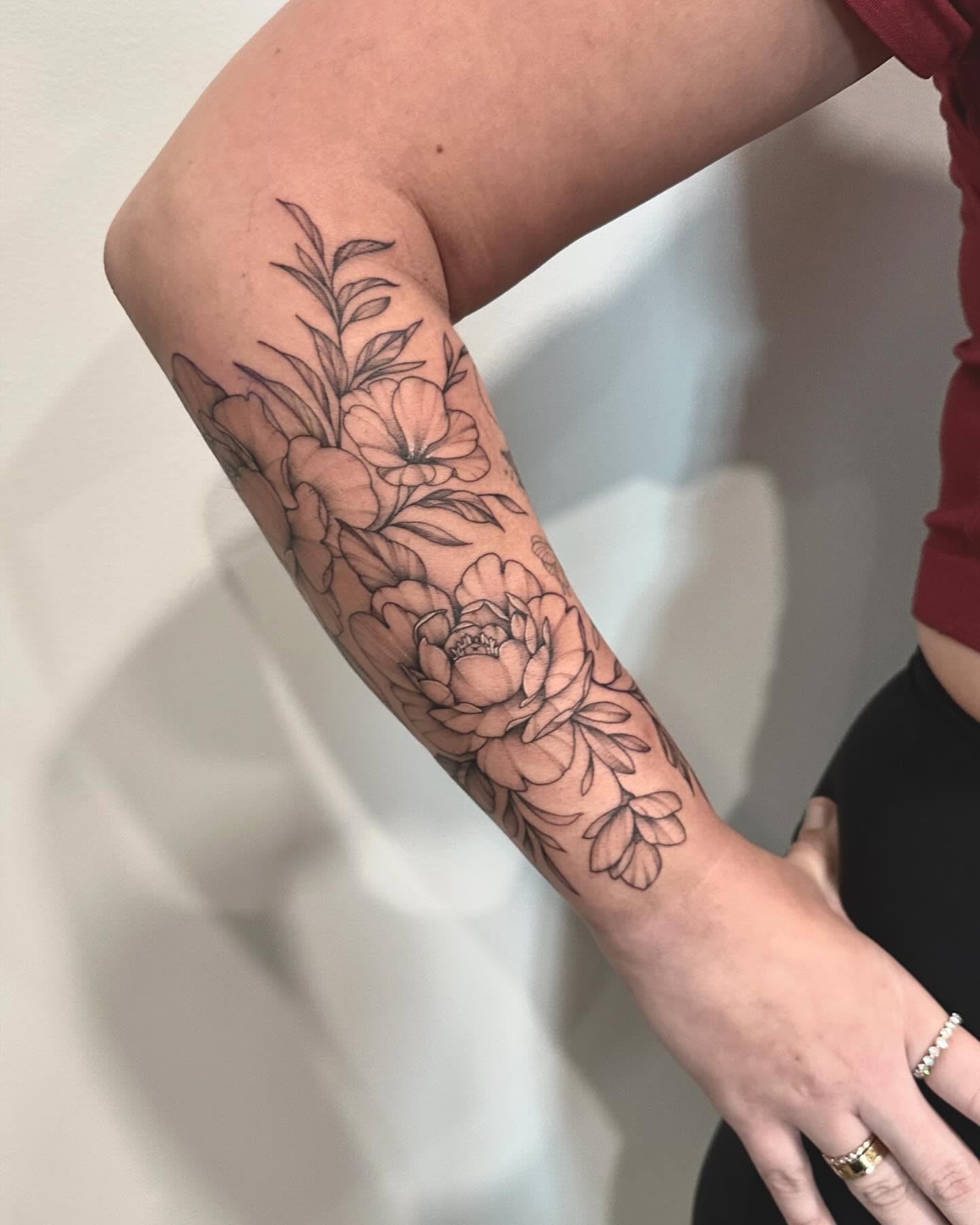 Floral bouquet black and grey tattoo on the forearm by Kate Darling