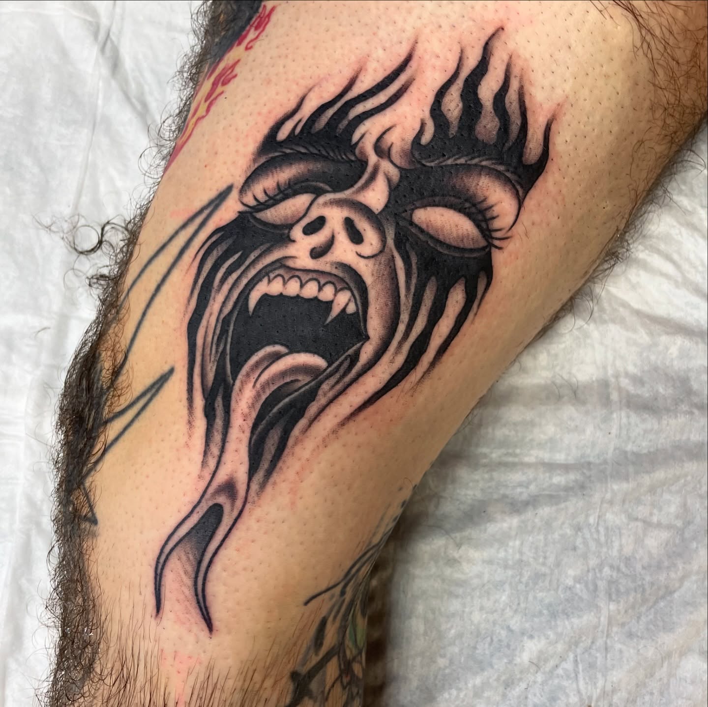 Flaming skull dark realism tattoo on the forearm by Tom Taylor, Philadelphia, Pennsylvania