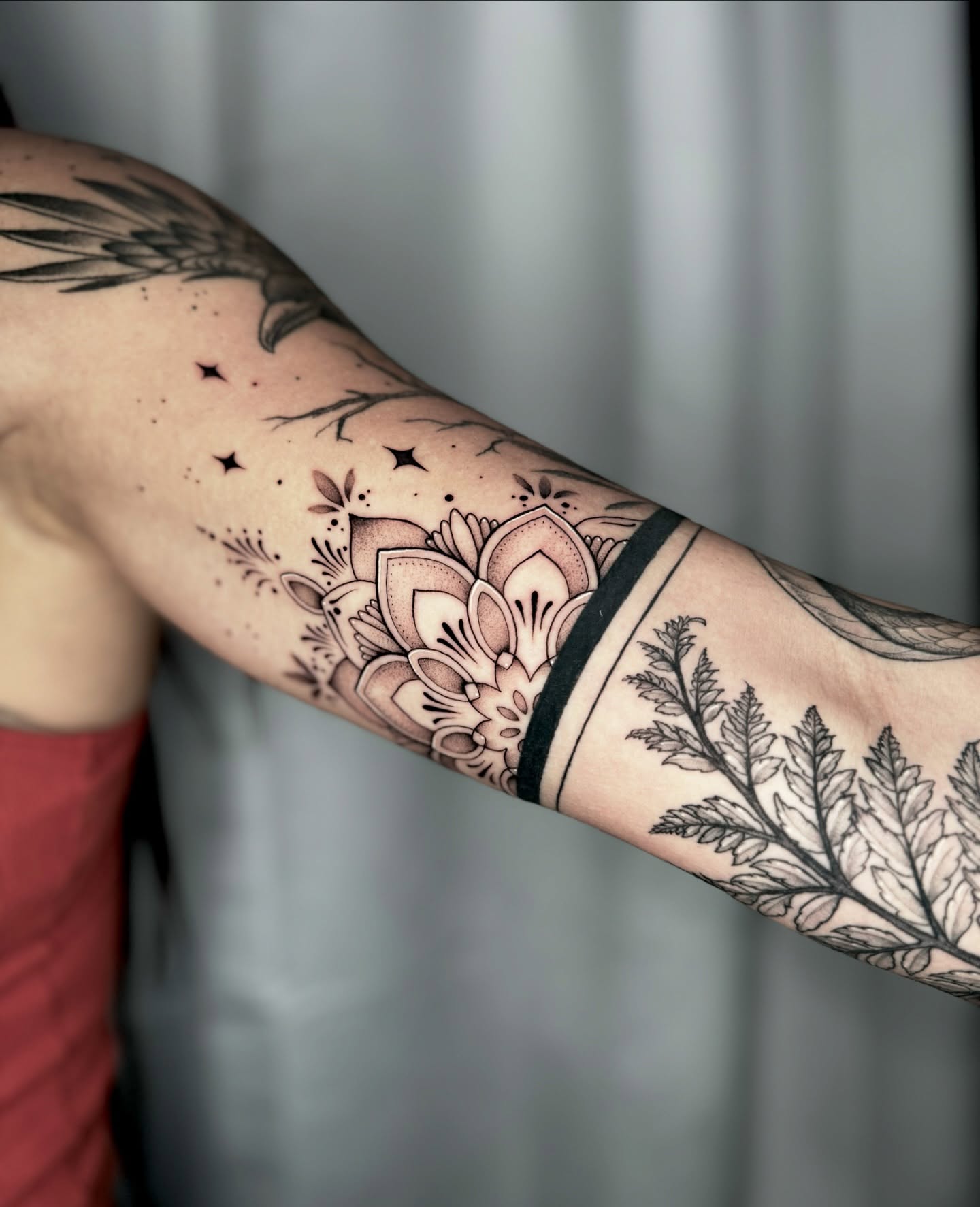 Floral and botanical ornamental tattoo on the forearm by Kathryn Semus