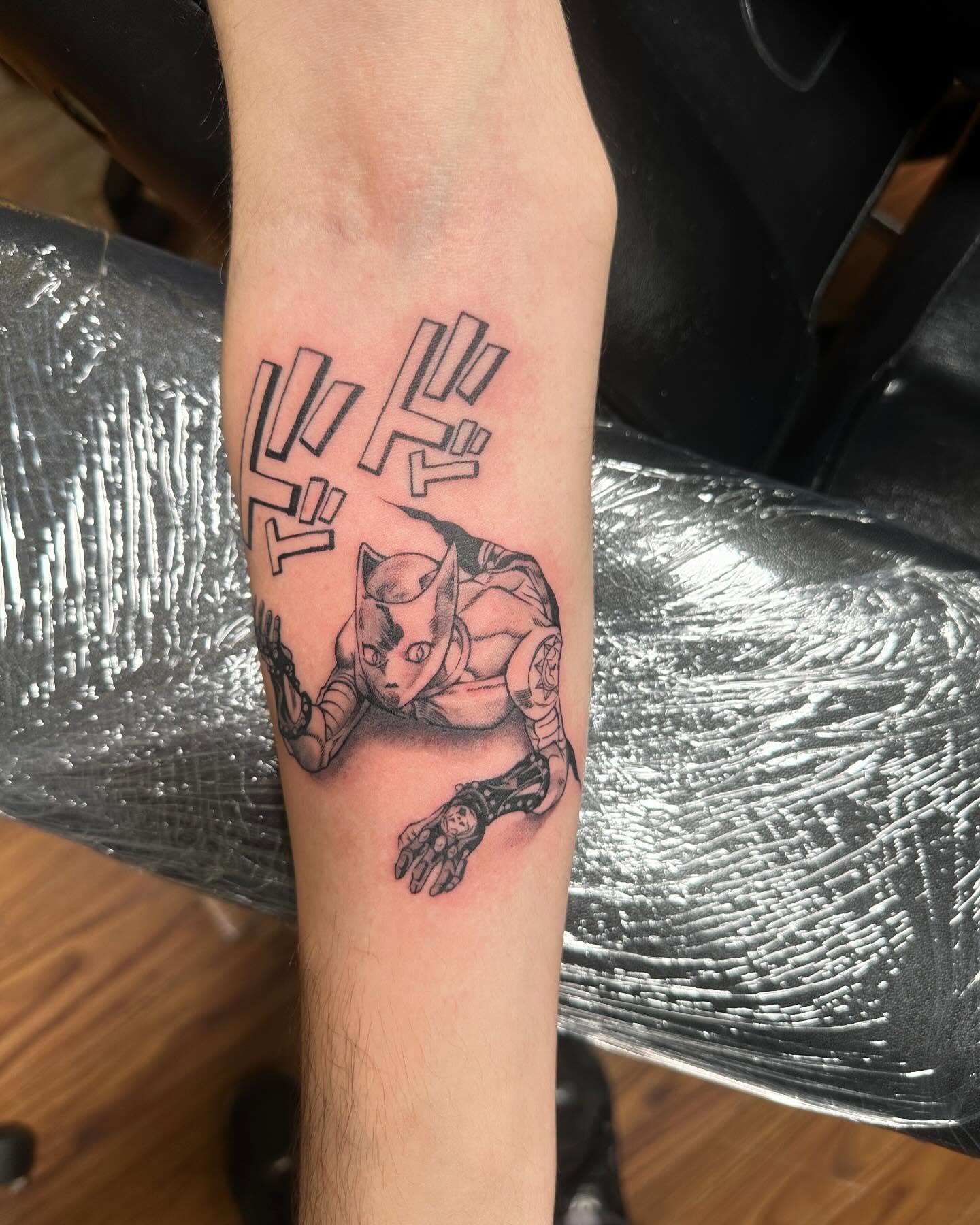 Cat-like robot black and grey tattoo on the forearm by Jan Xander