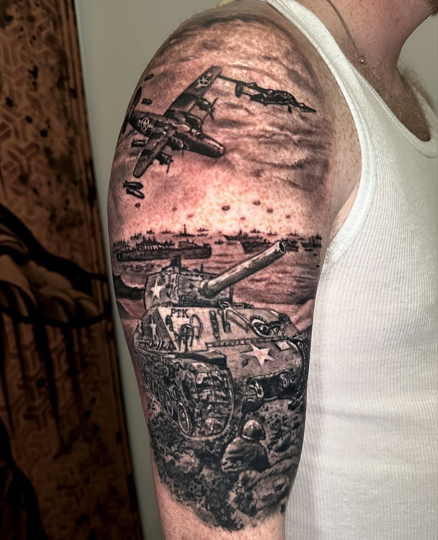 Tank battle scene realism tattoo on the forearm by Ty Pallotta, Austin, Texas