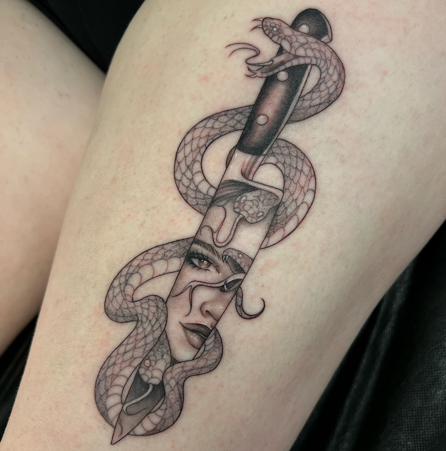 Snake and knife realism tattoo on the thigh by ✨ Jaden Belle Tattoos ✨