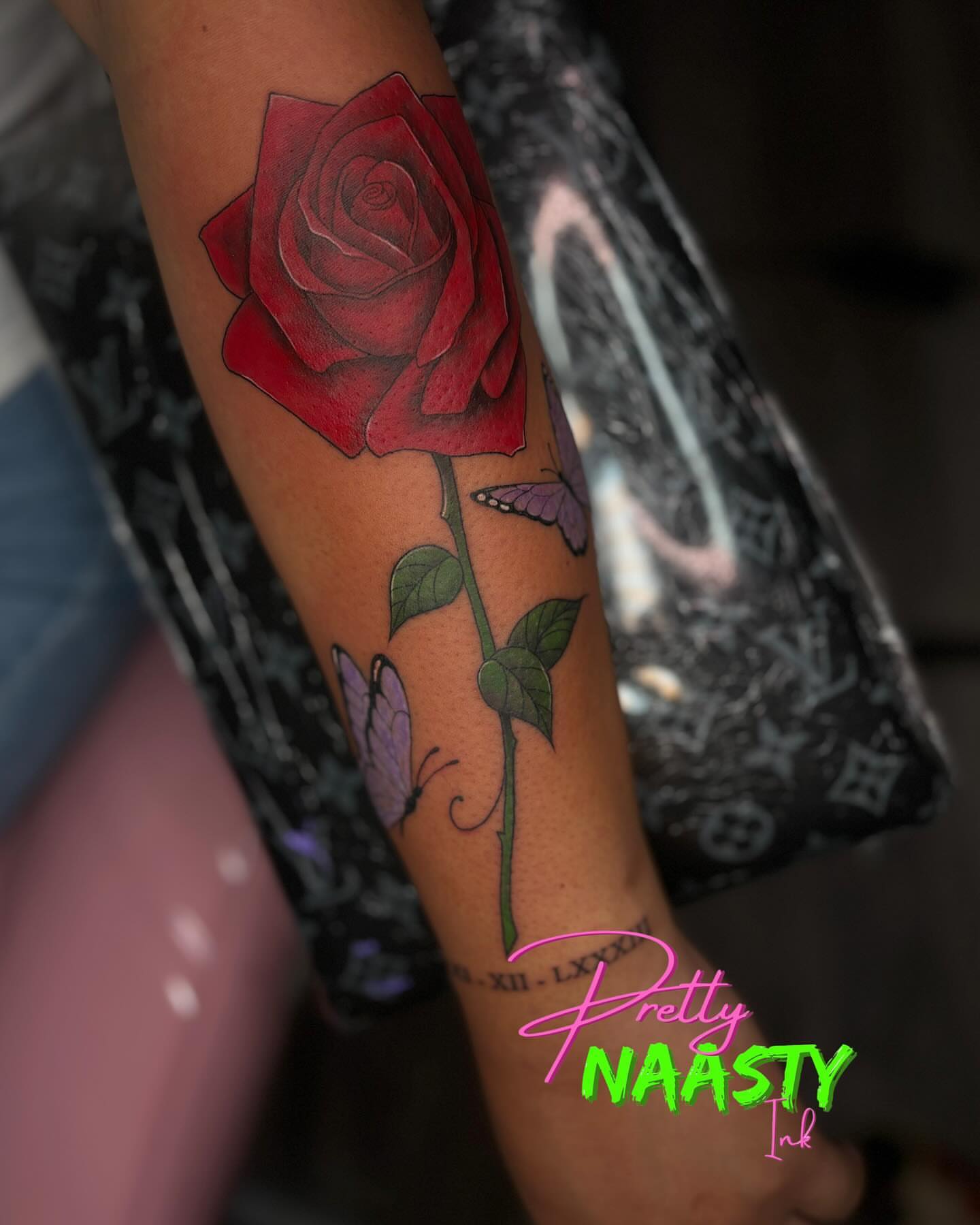Red rose realism tattoo on the forearm by Pretty Naasty Ink🖤