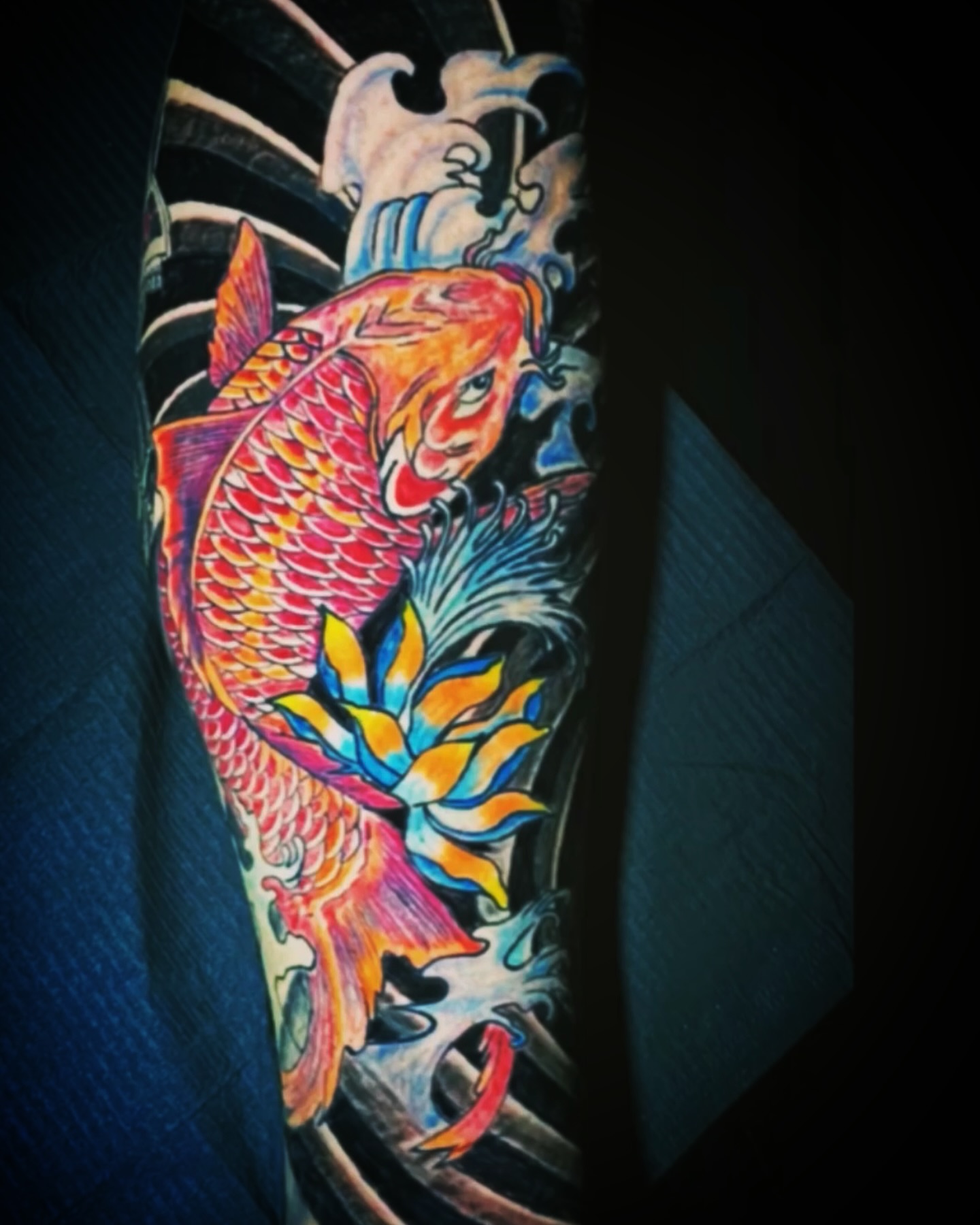 Koi fish and lotus japanese irezumi tattoo on the forearm by Erasmo Vasquez