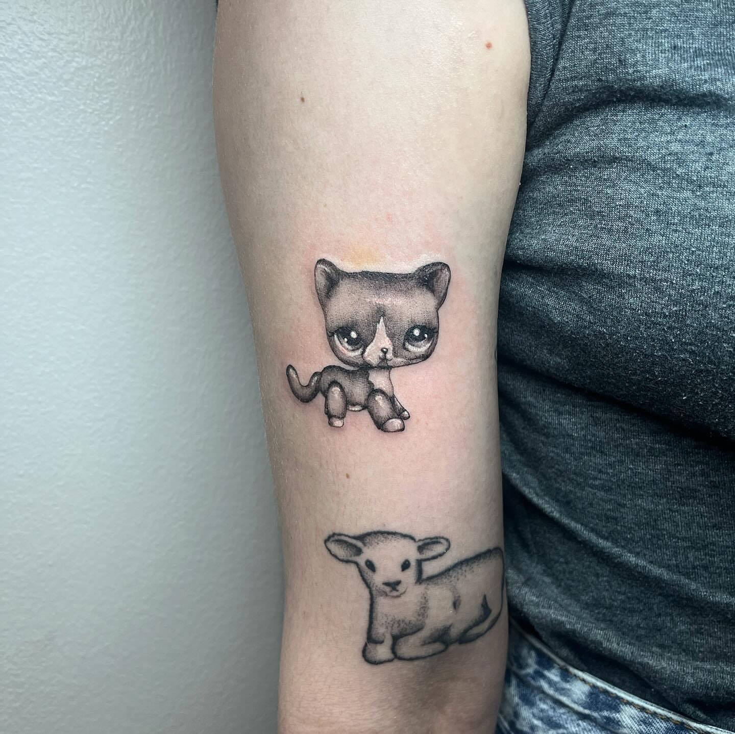 Cat and lamb dotwork tattoo on the forearm by aurora