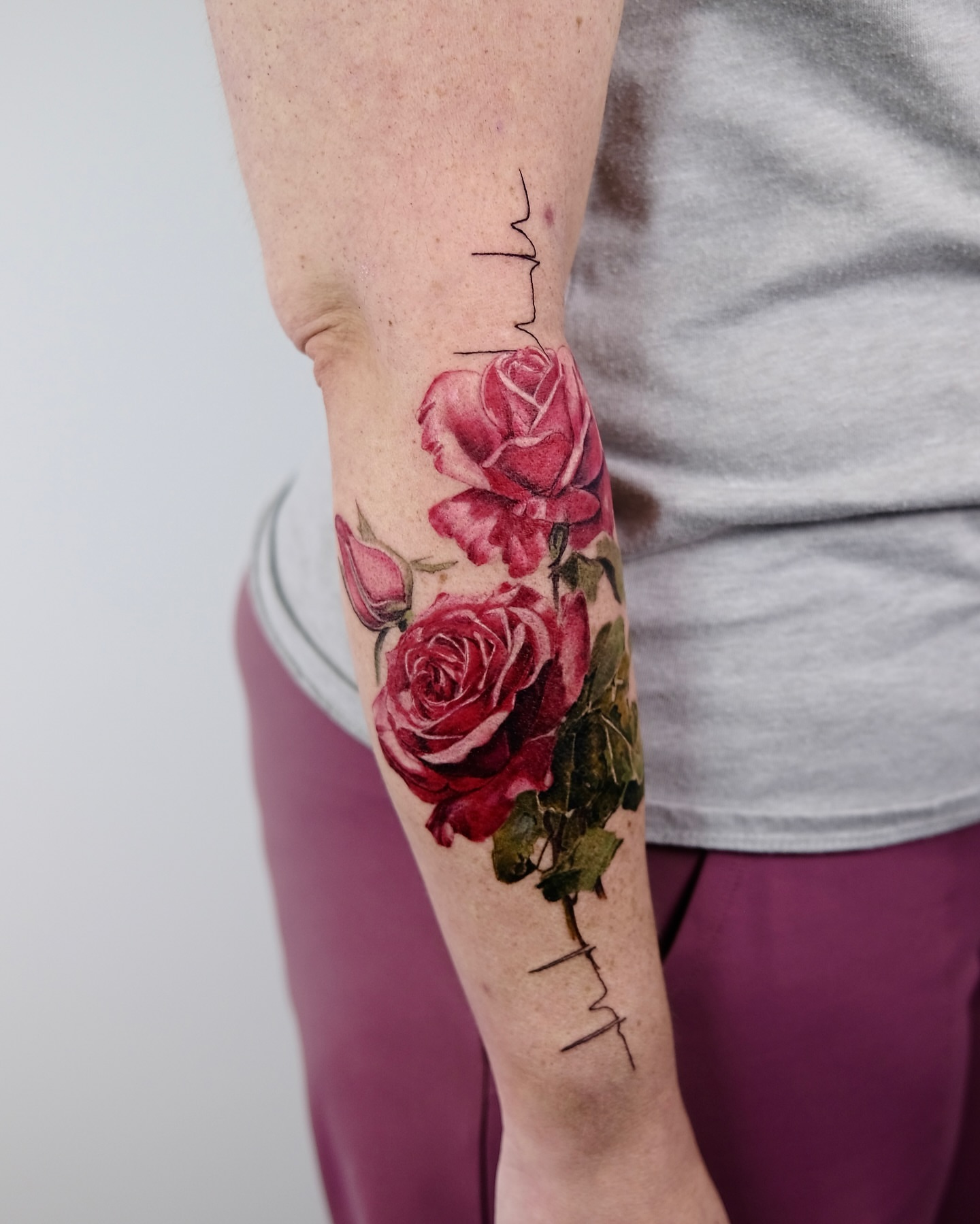 Roses realism tattoo on the forearm by Henry