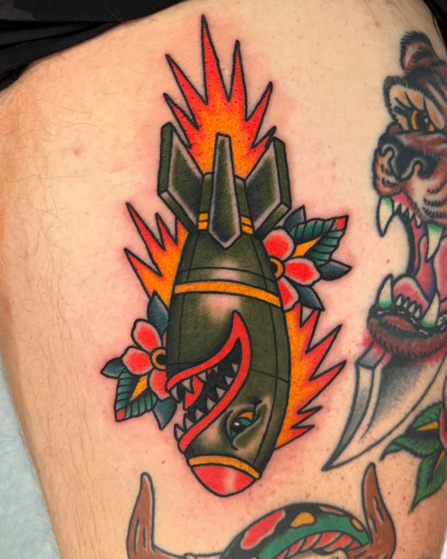 Bomb with flames American traditional tattoo on the thigh by Jared, Addison, Texas