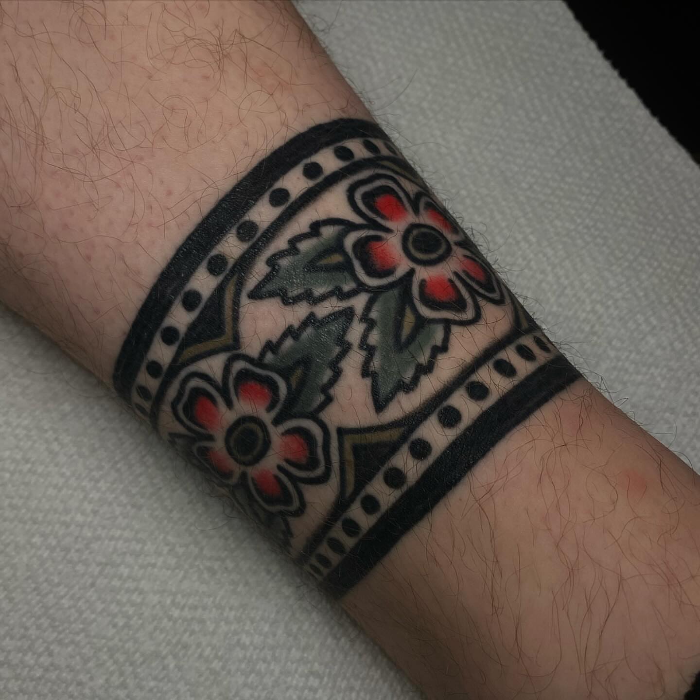 Floral pattern American traditional tattoo on the forearm by Erin Chambers