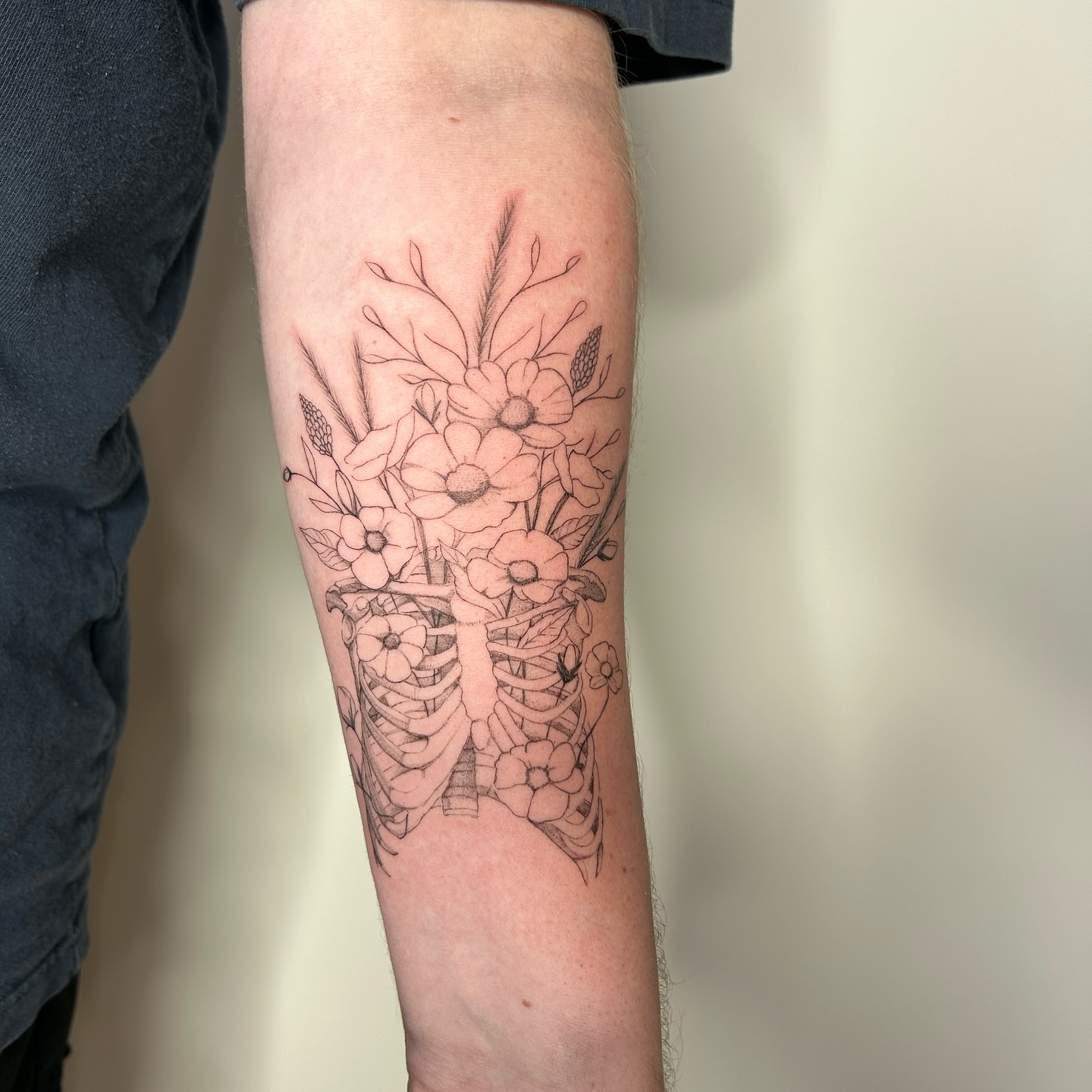 Floral bouquet black and grey tattoo on the forearm by bre