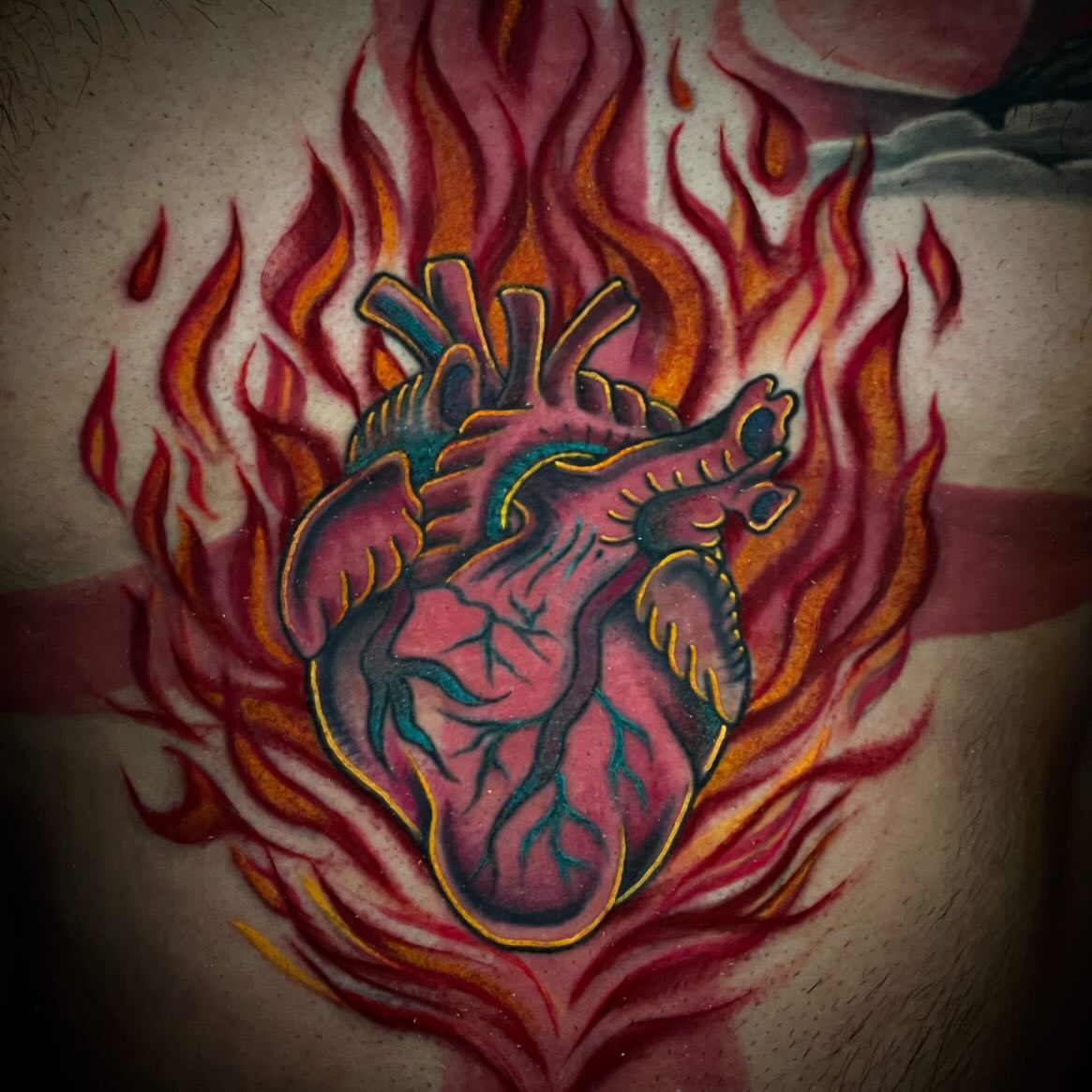Heart American traditional tattoo on the chest by Madison ‘Maddog’ Stewart