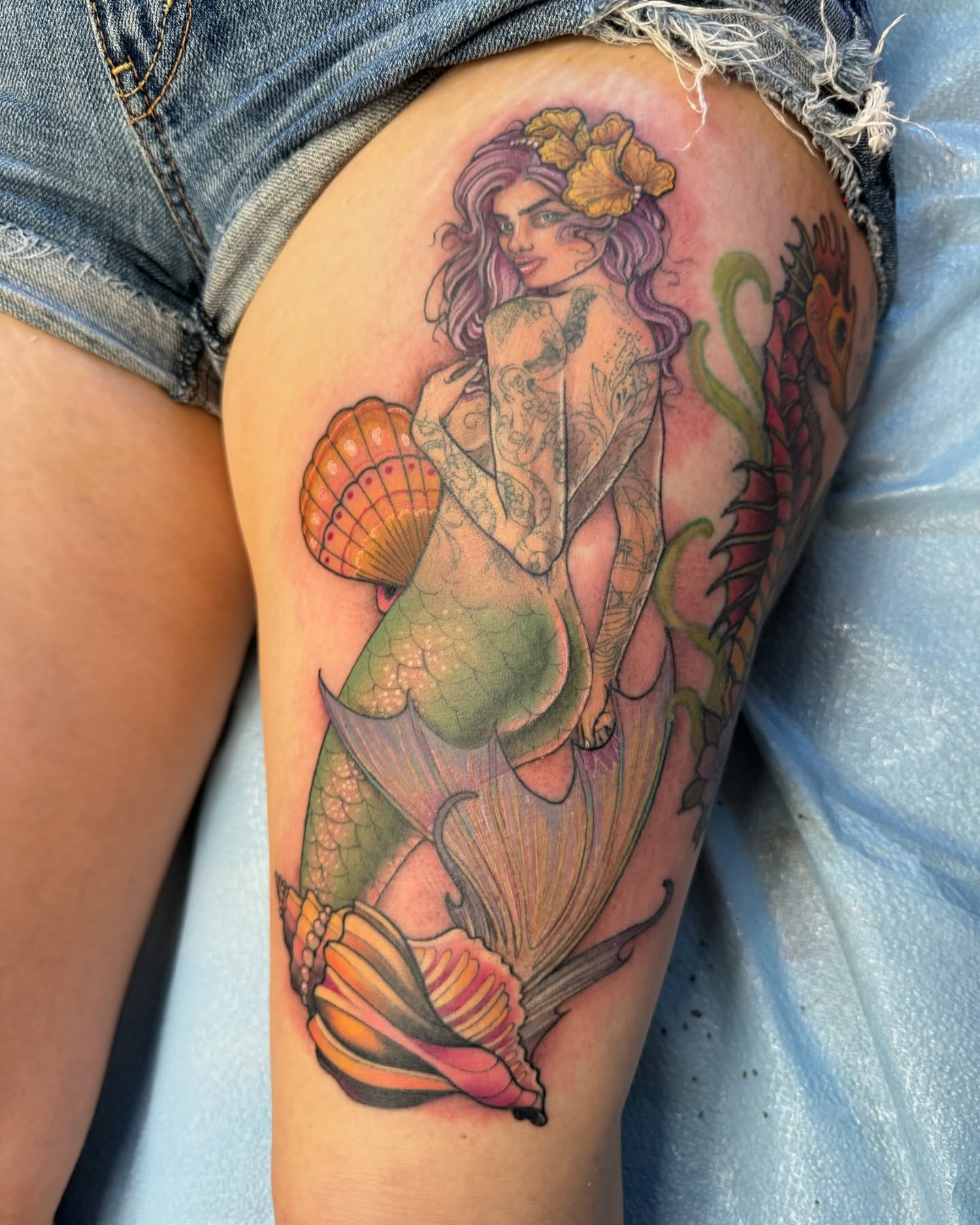 Mermaid illustrative tattoo on the thigh by sam cedar geller 🐝