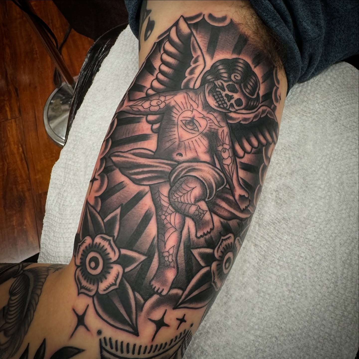 Skeleton with eye American traditional tattoo on the forearm by Rogelio Robles