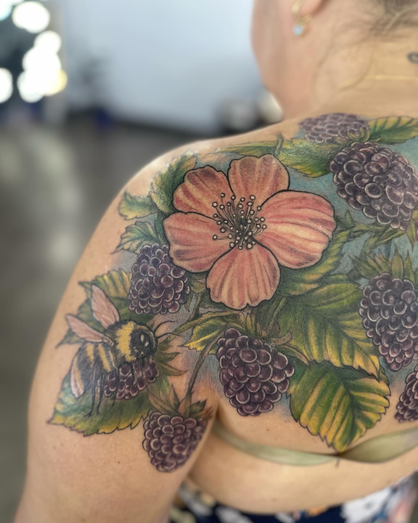 Flower and berries realism tattoo on the shoulder by Cameron Hobbs, Woodbridge, Virginia
