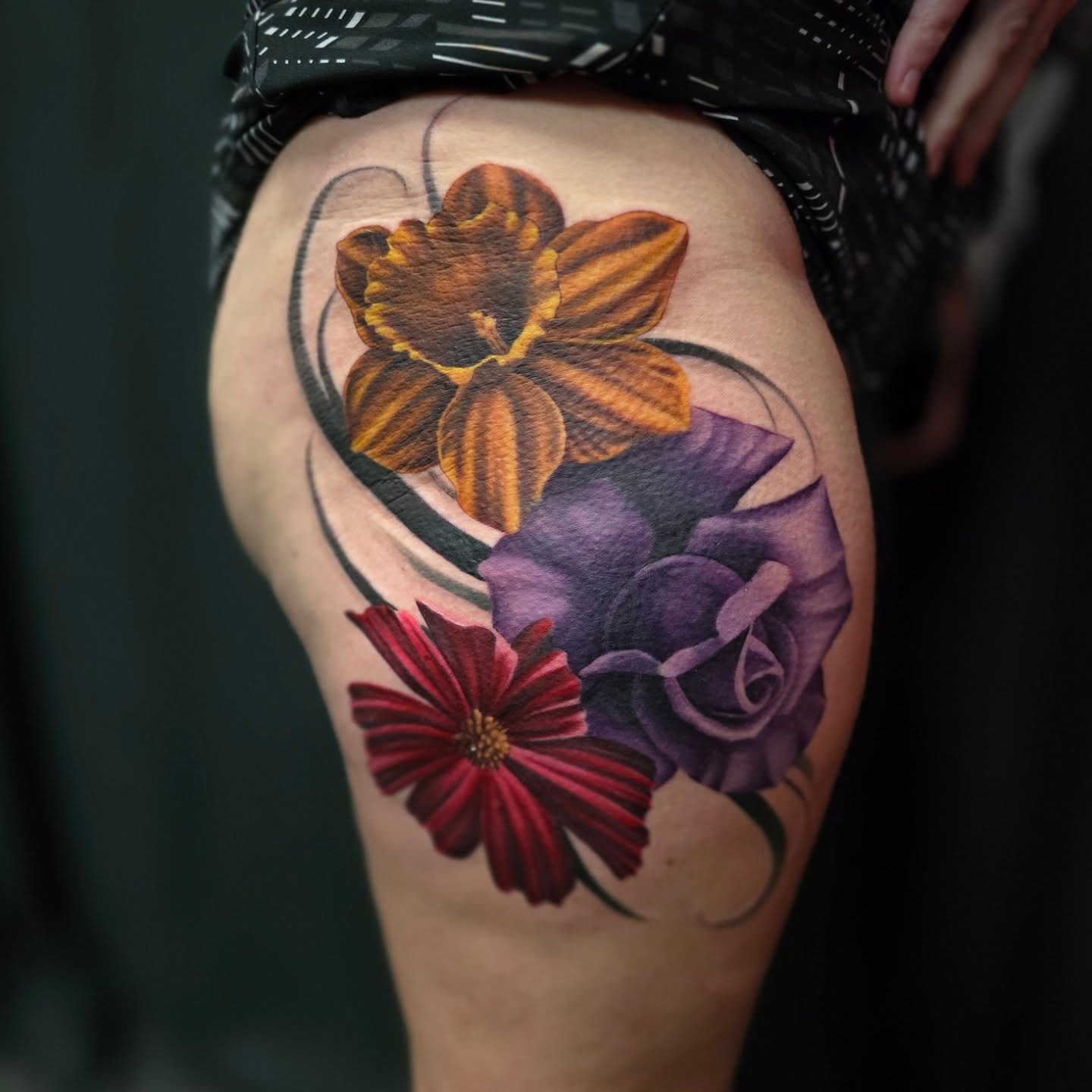 Floral arrangement realism tattoo on the thigh by Gabrielle Nicole Soucie