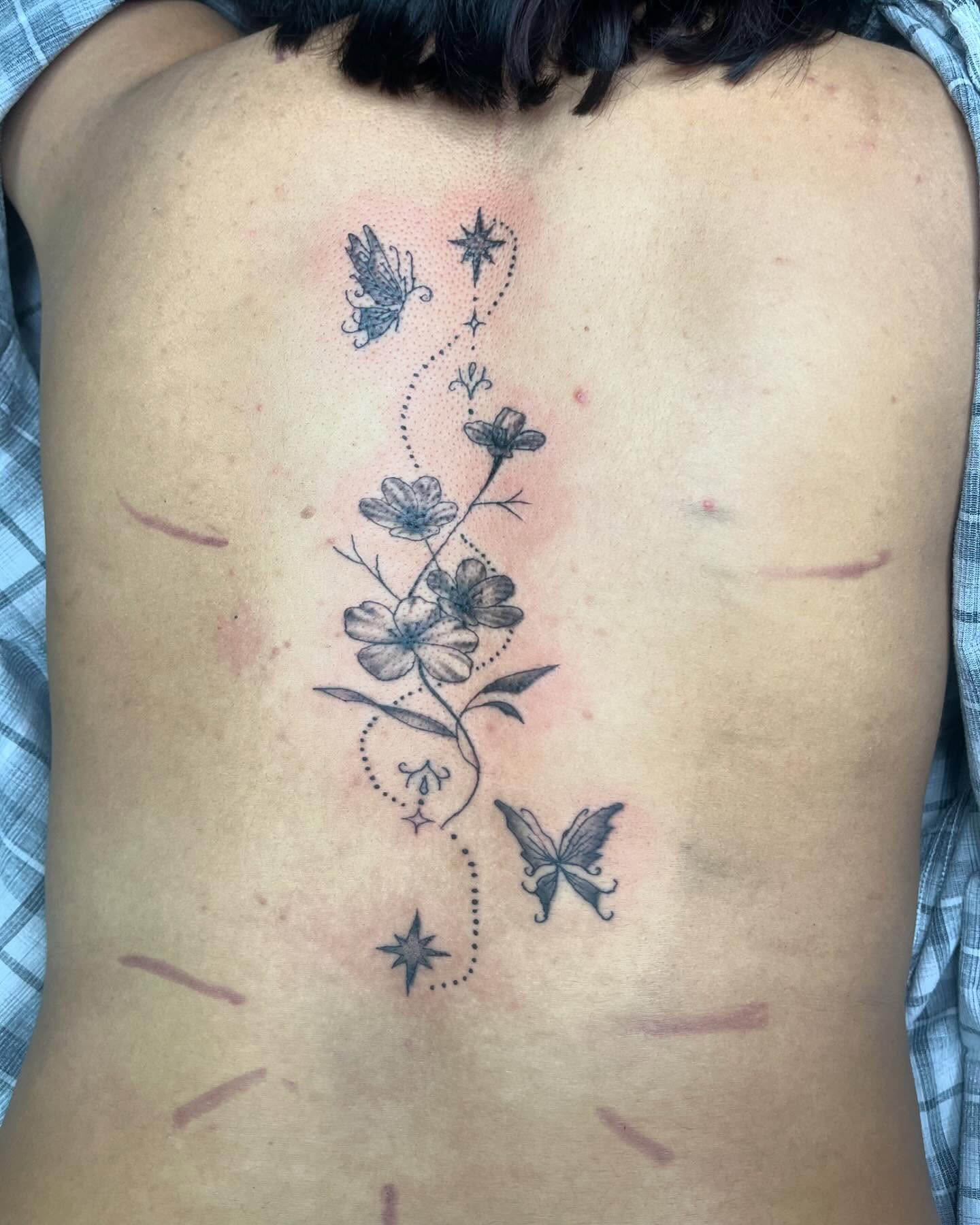 Flowers and butterflies dotwork tattoo on the back by destiny🌞