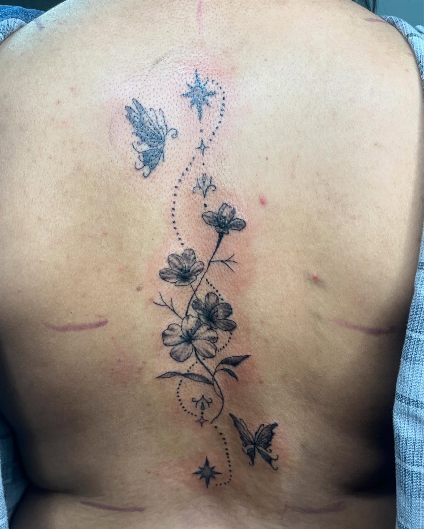 Flowers and butterflies dotwork tattoo on the back by destiny🌞