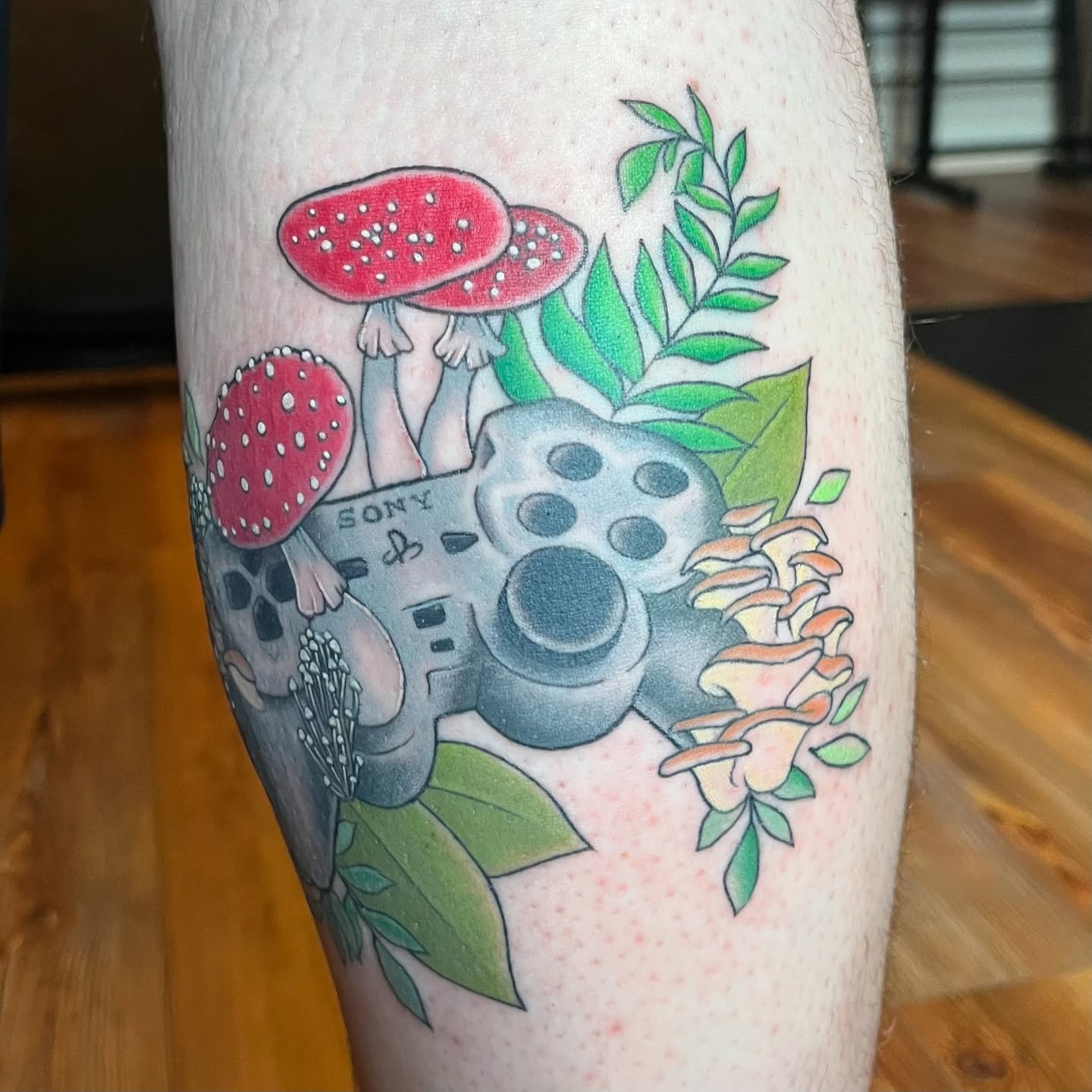 Video game controller with mushrooms dotwork tattoo on the leg by Krystal ✨