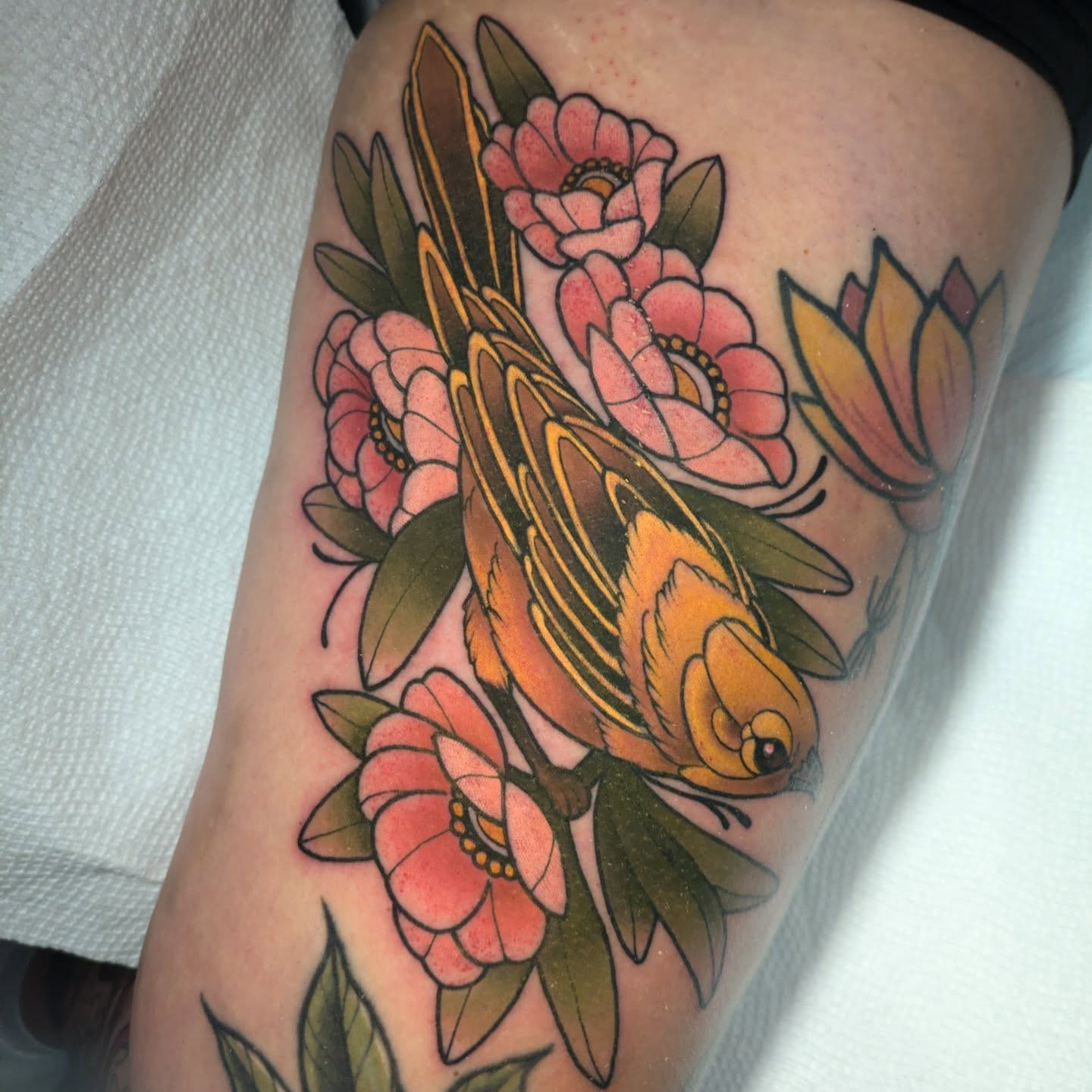 Bird and flowers American traditional tattoo on the thigh by Ellie