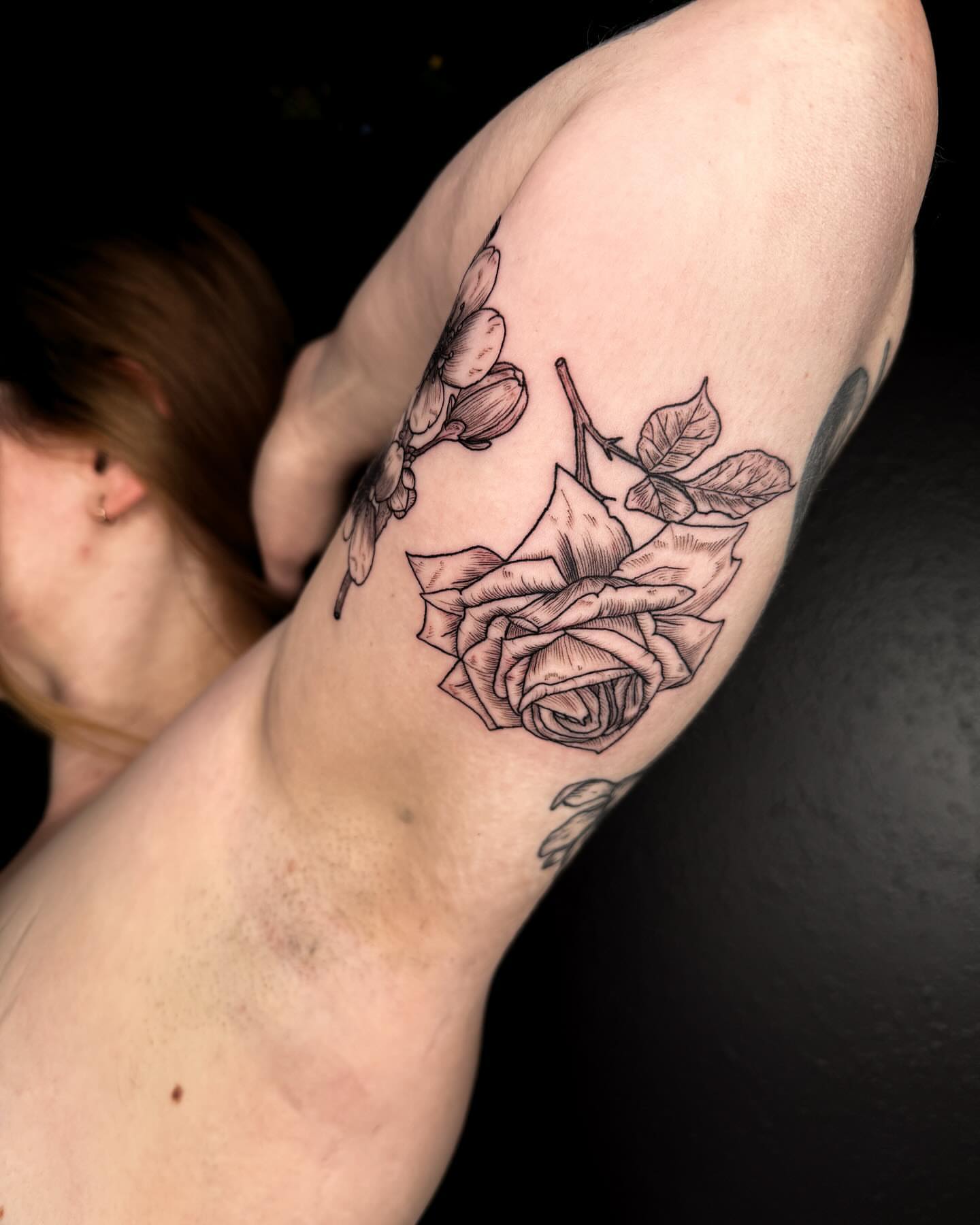 Rose black and grey tattoo on the forearm by Zella Mäkelä